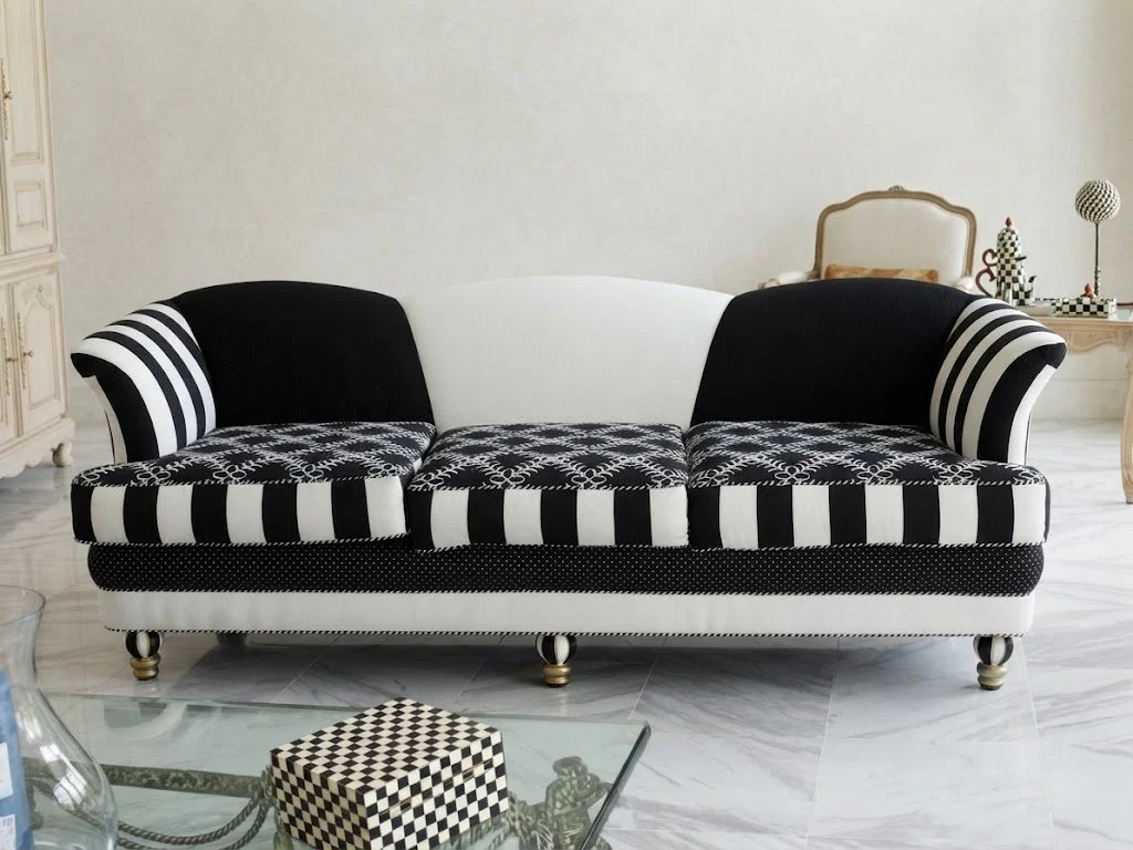 Custom upholstered black and white patterned sofa with striking striped details, crafted by London Stitchery in Fort Lauderdale.