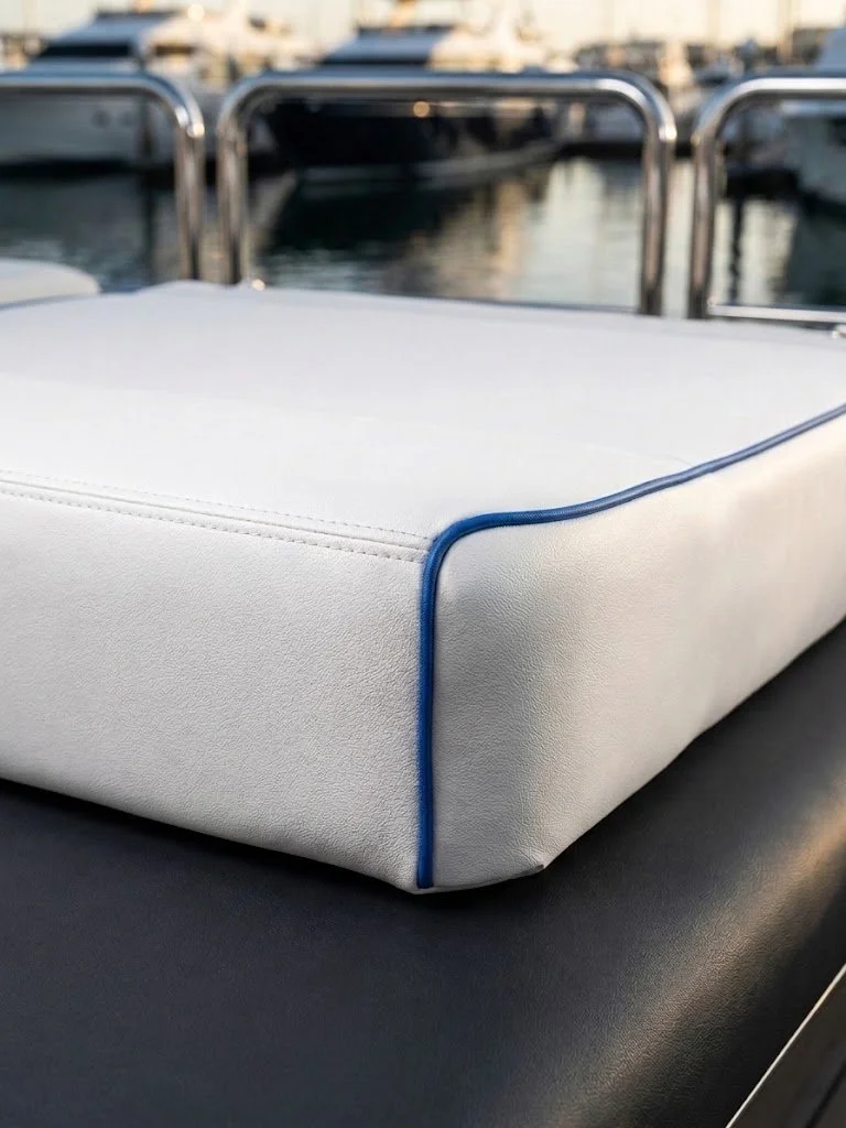 Custom white marine cushion with blue contrast piping and yacht interior upholstery handcrafted in Fort Lauderdale by London Stitchery.