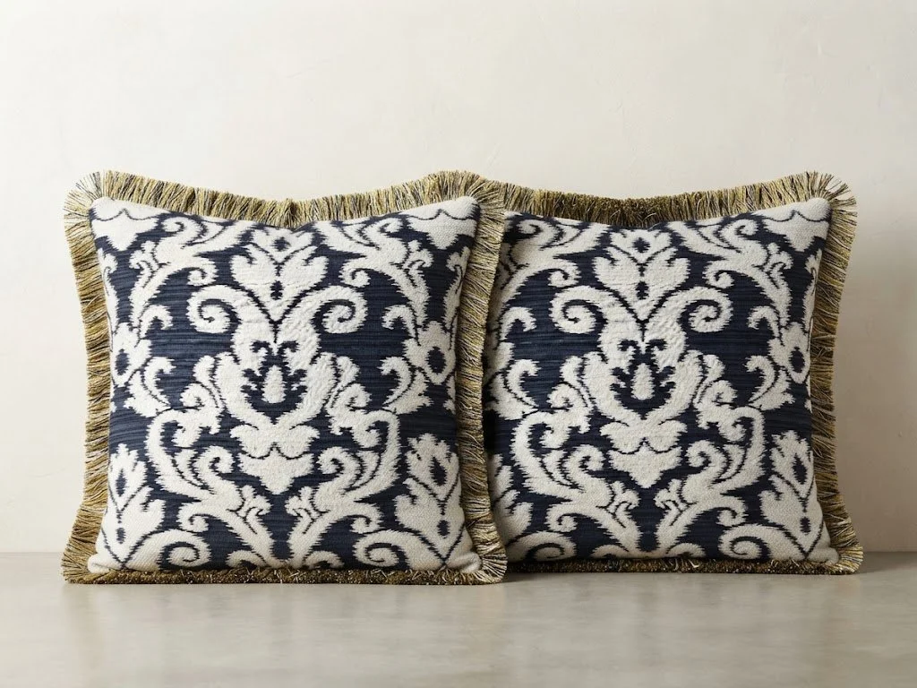 Custom decorative accent pillows finished with an elegant brush fringe trim, hand-tailored by London Stitchery.