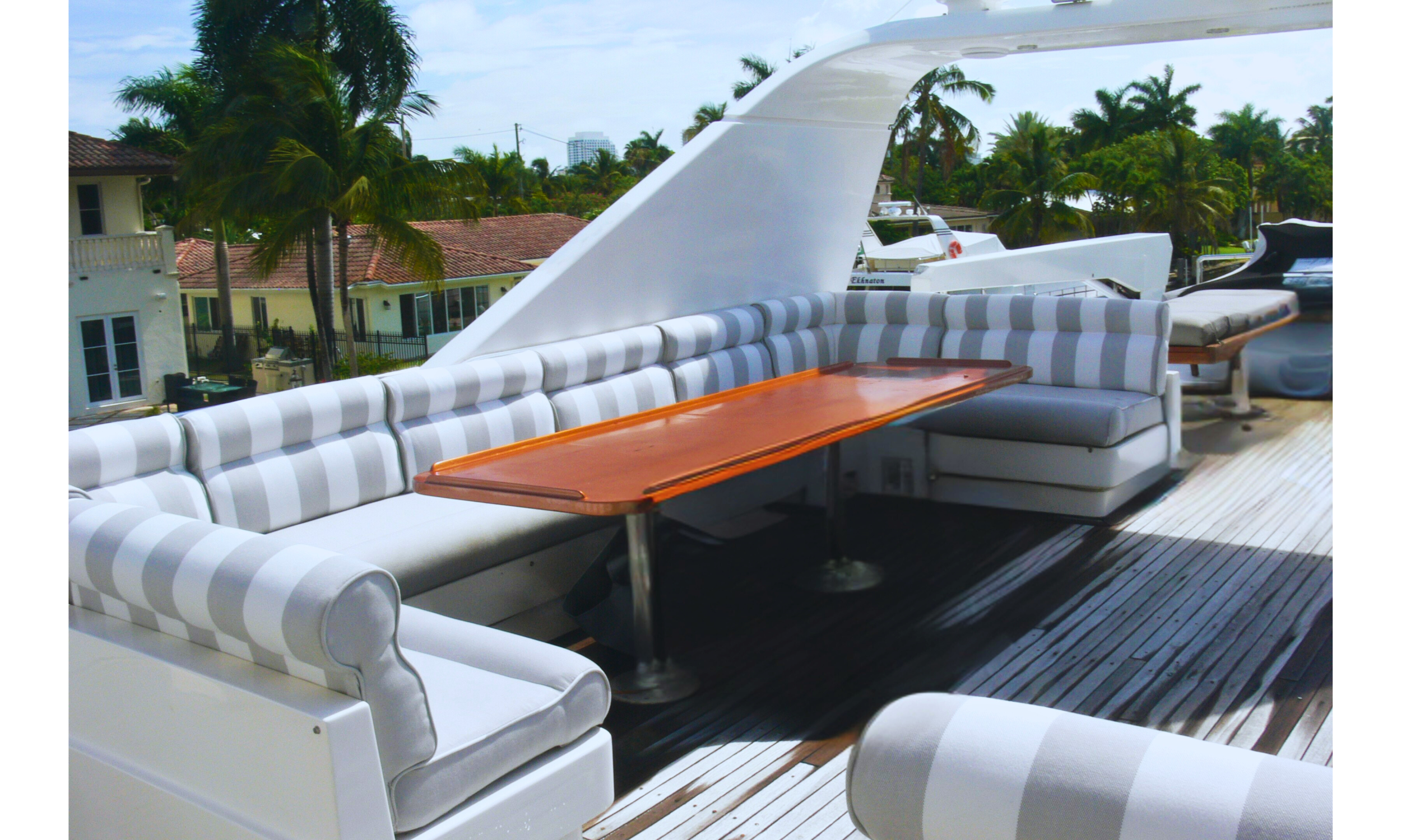 Luxury Yacht Seating: Custom-tailored upper deck cushions with a classic nautical stripe, providing a sophisticated and comfortable outdoor entertaining space."