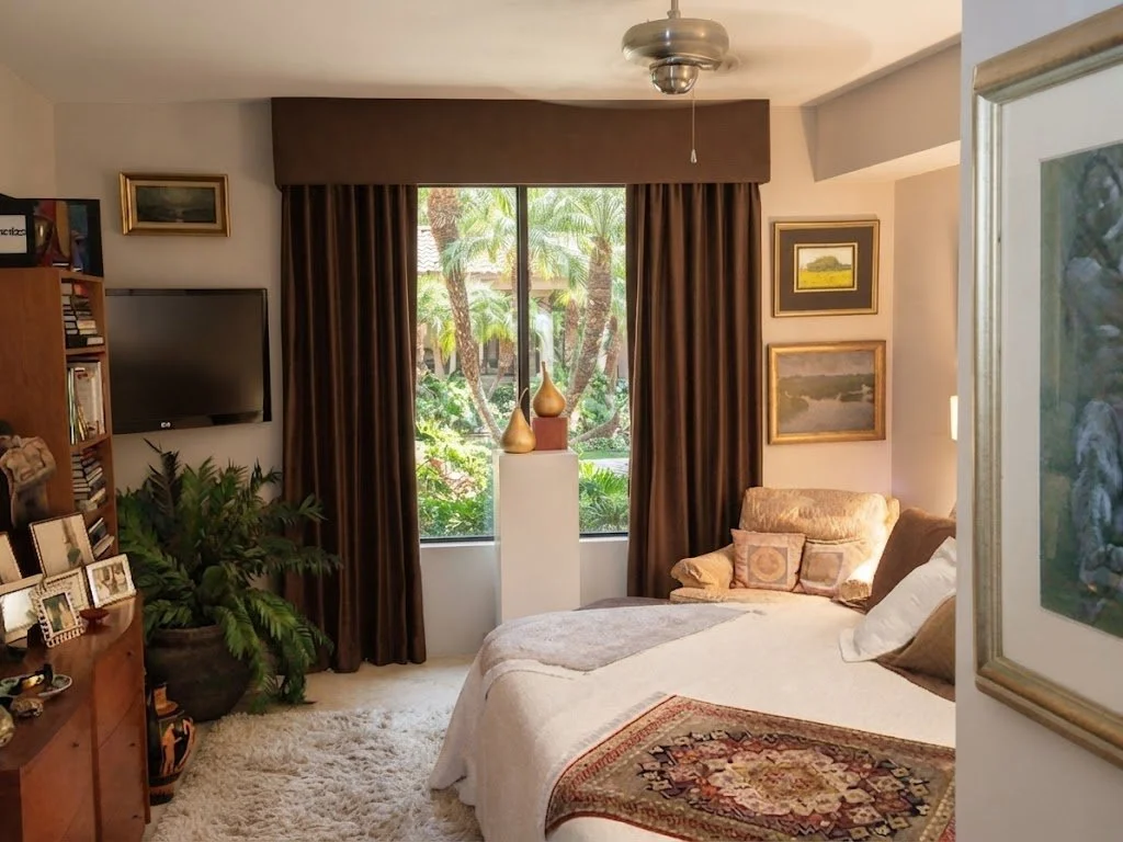 Rich chocolate brown custom draperies paired with a tailored upholstered cornice, designed for a luxury bedroom suite by London Stitchery.