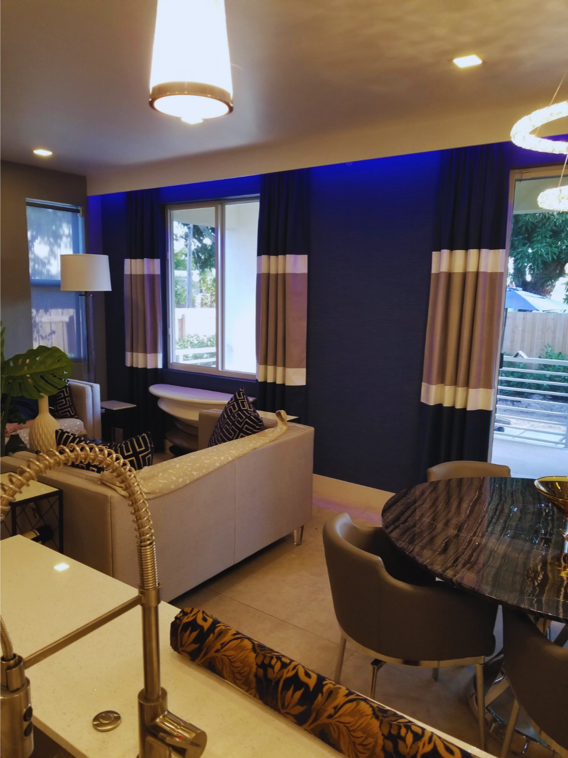 Custom horizontal color-blocked drapery panels in a luxury blue dining room, precision-fabricated by London Stitchery workroom in Fort Lauderdale.