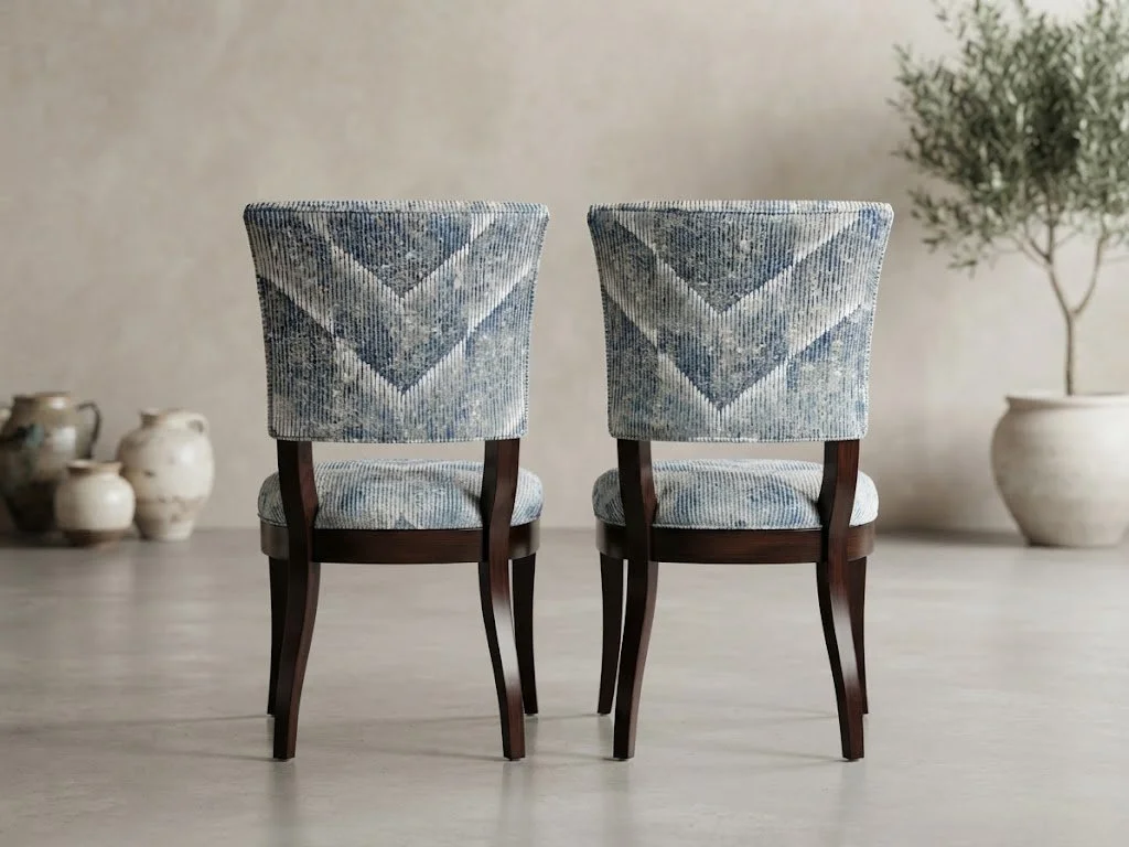 Custom-upholstered dining chairs featuring precision pattern-matched chevron fabric across the backs, showcasing expert craftsmanship by London Stitchery.