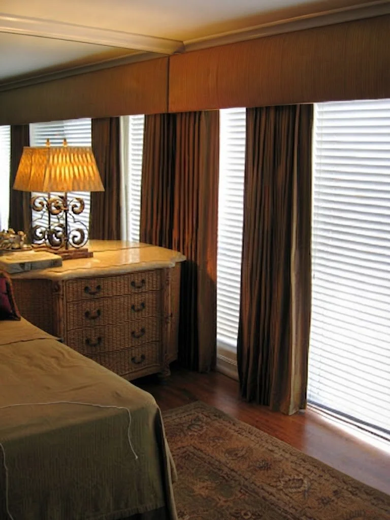 Luxurious silk interlined drapery panels paired with a custom-tailored cornice, designed for an elegant bedroom suite by London Stitchery.