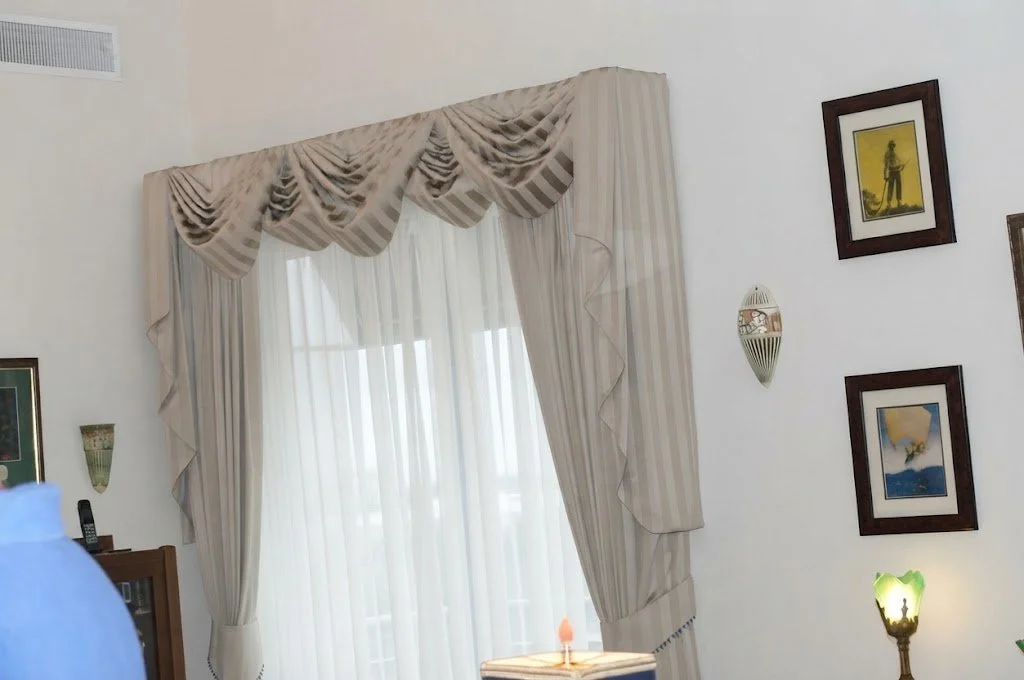 Custom-tailored traditional swag and tail window treatment featuring rich cascading drapery and intricate pleating, hand-crafted by London Stitchery.