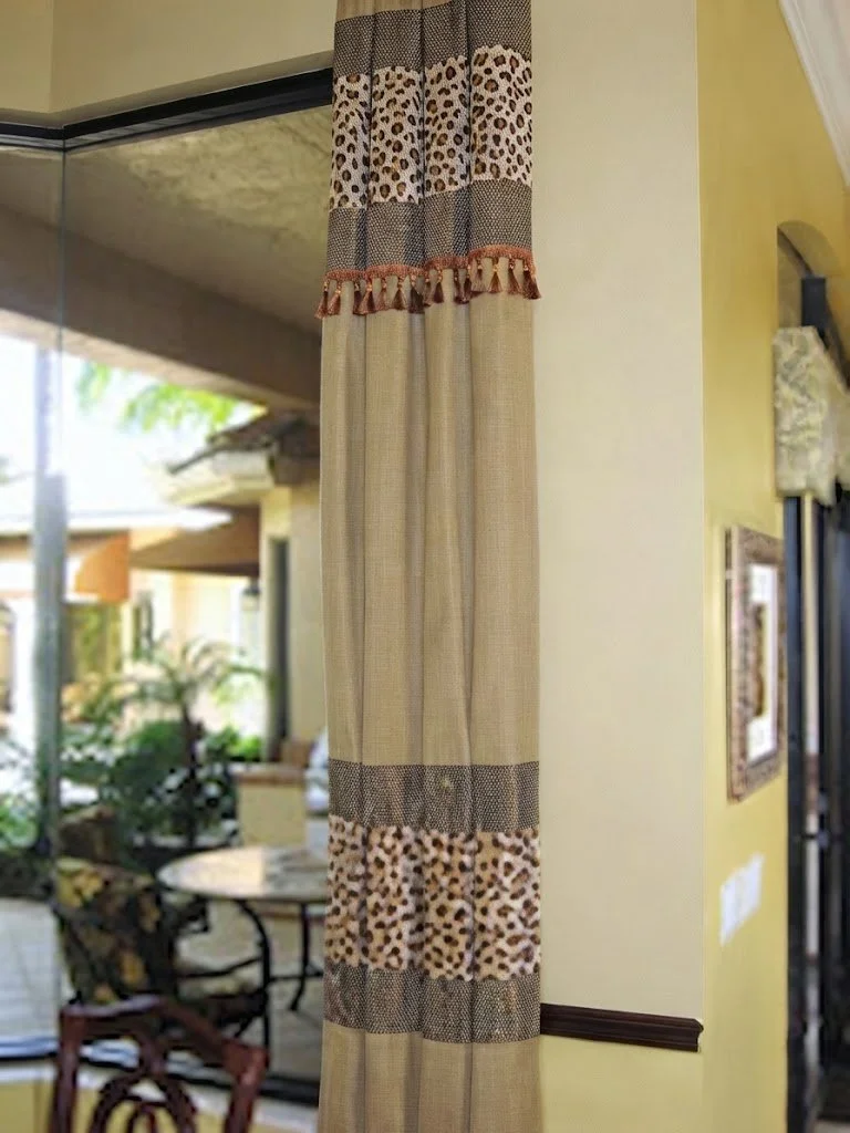 Custom floor-length drapery featuring a statement animal-print accent band and decorative trim, hand-crafted for luxury interior spaces by London Stitchery.