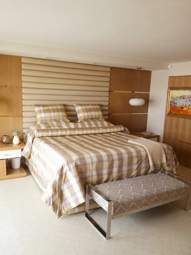 Bespoke tailored comforter and matching pillows in a sophisticated neutral plaid fabric, designed to create a warm and inviting bedroom retreat.