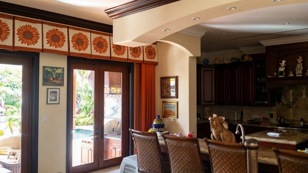 Custom-crafted valance featuring a vibrant floral daisy pattern band, paired with coordinated drapery panels for an elegant dining room window treatment by London Stitchery.