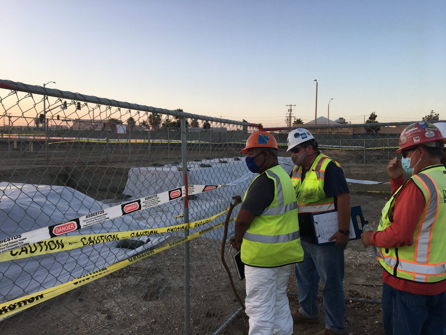 People in safety gear reviewing a construction site