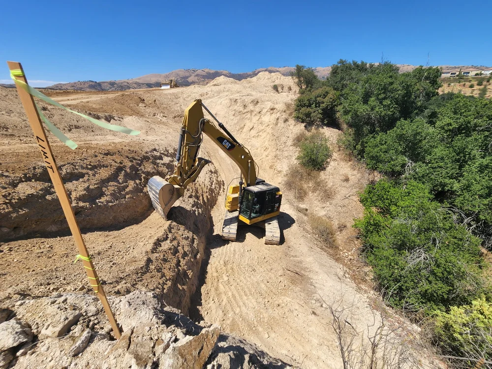 Excavator working on an open earthwork site