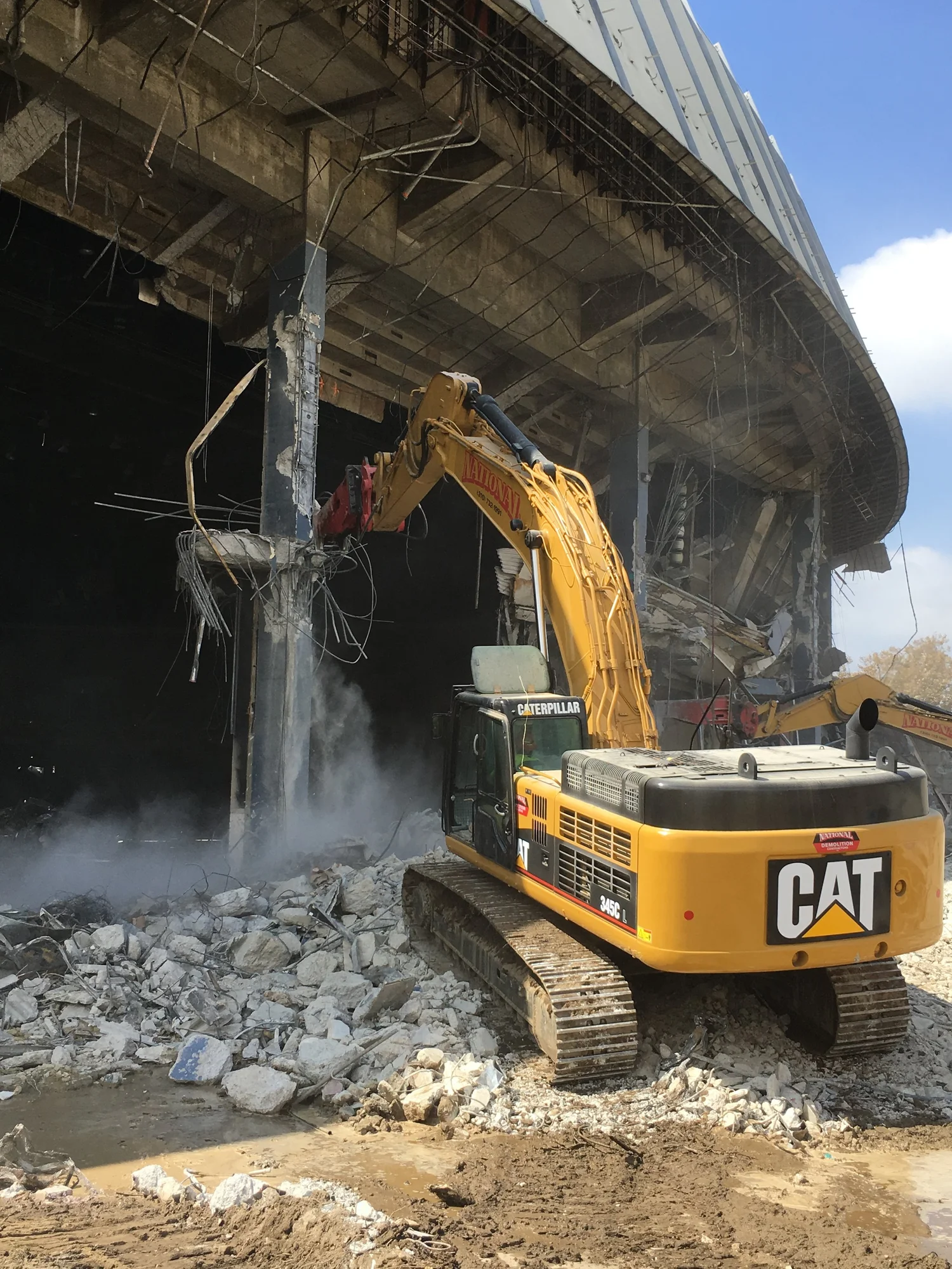 Excavator working inside a structure during demolition