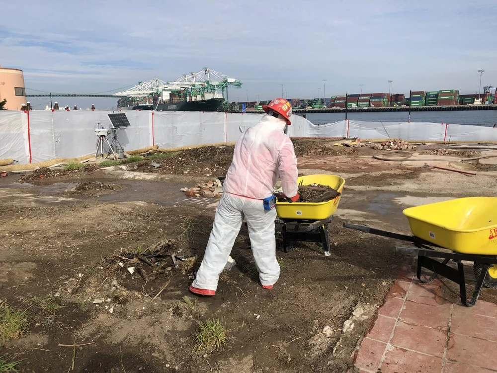Worker with a wheelbarrow on an outdoor site