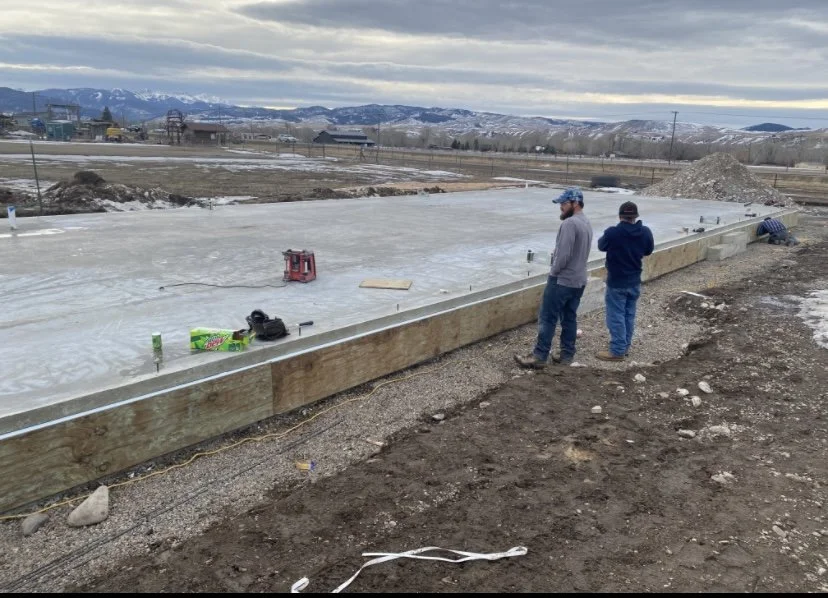 Two people reviewing conditions at a construction site