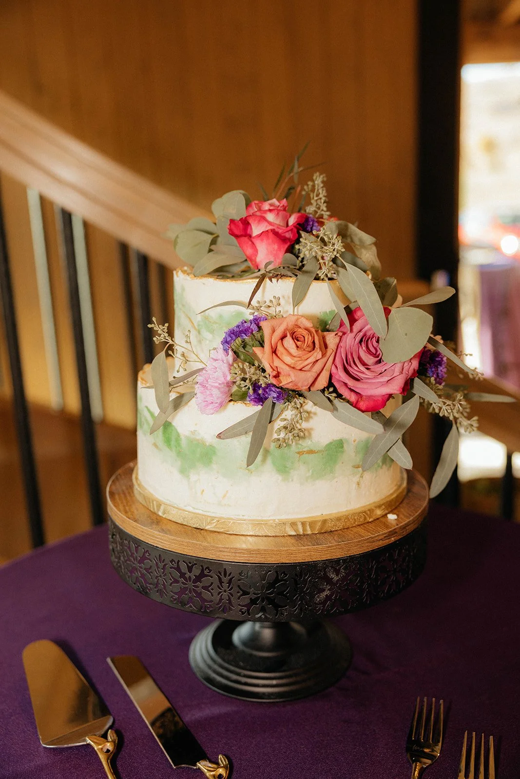 Wedding cake display inside rustic Utah lodge venue