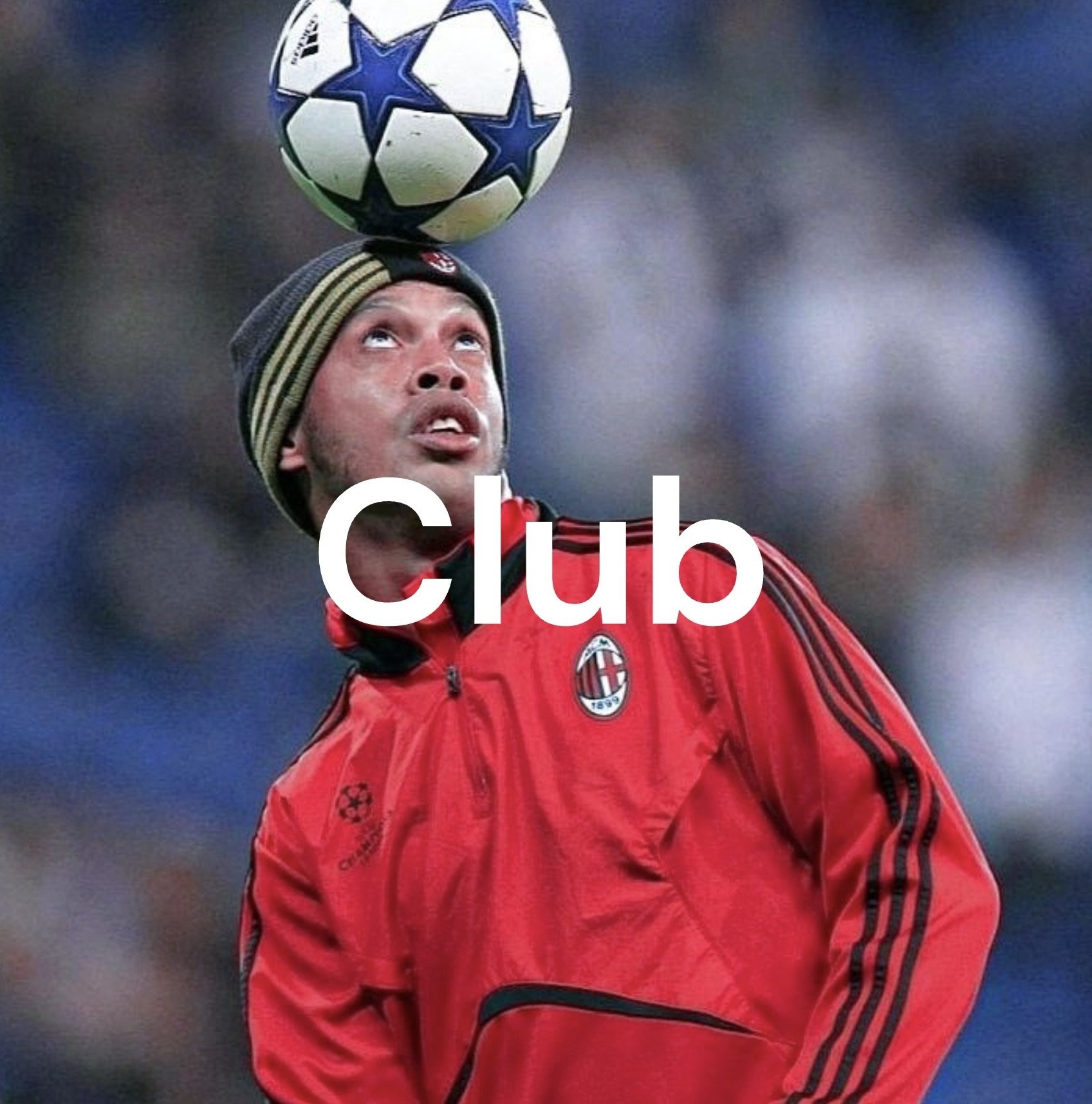 A man in a red AC Milan jacket and beanie balancing a soccer ball on his head during a match.