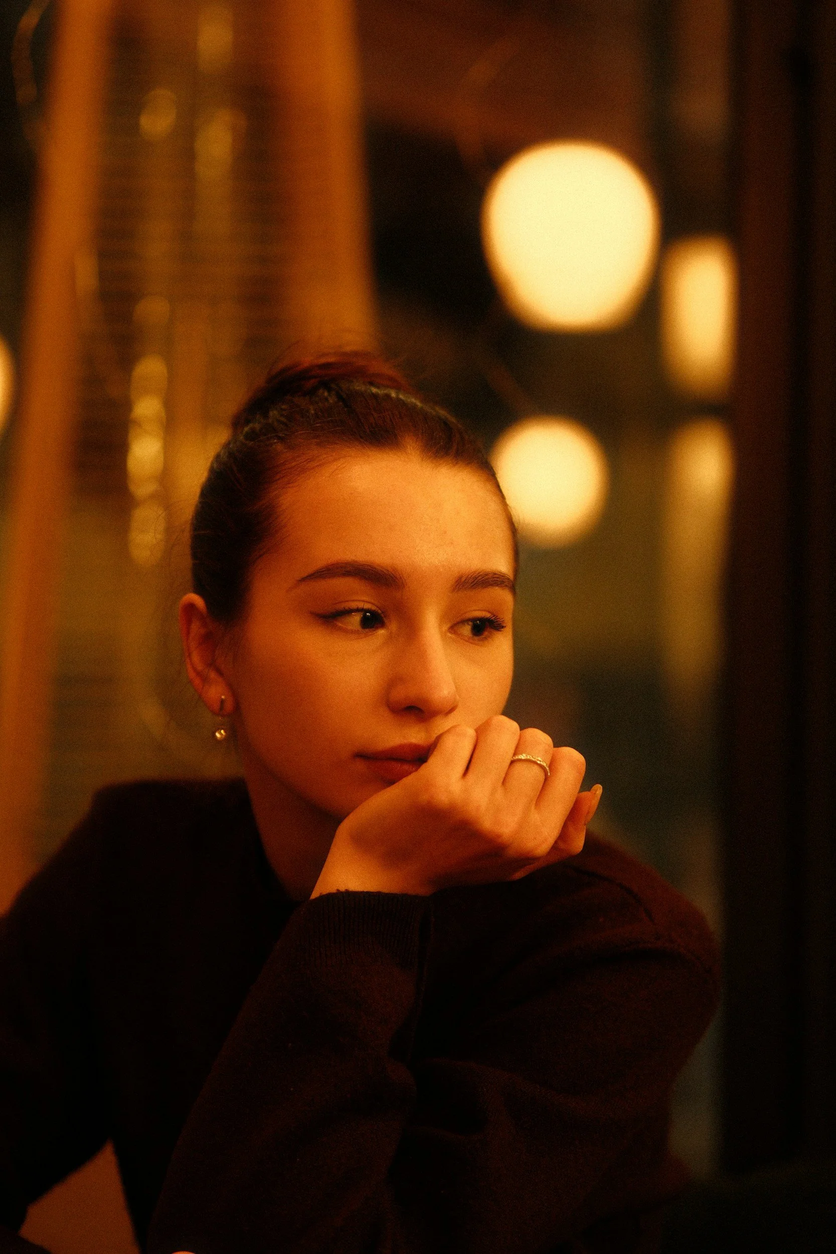 Woman sitting thoughtfully, reflecting on the effects of sexual trauma