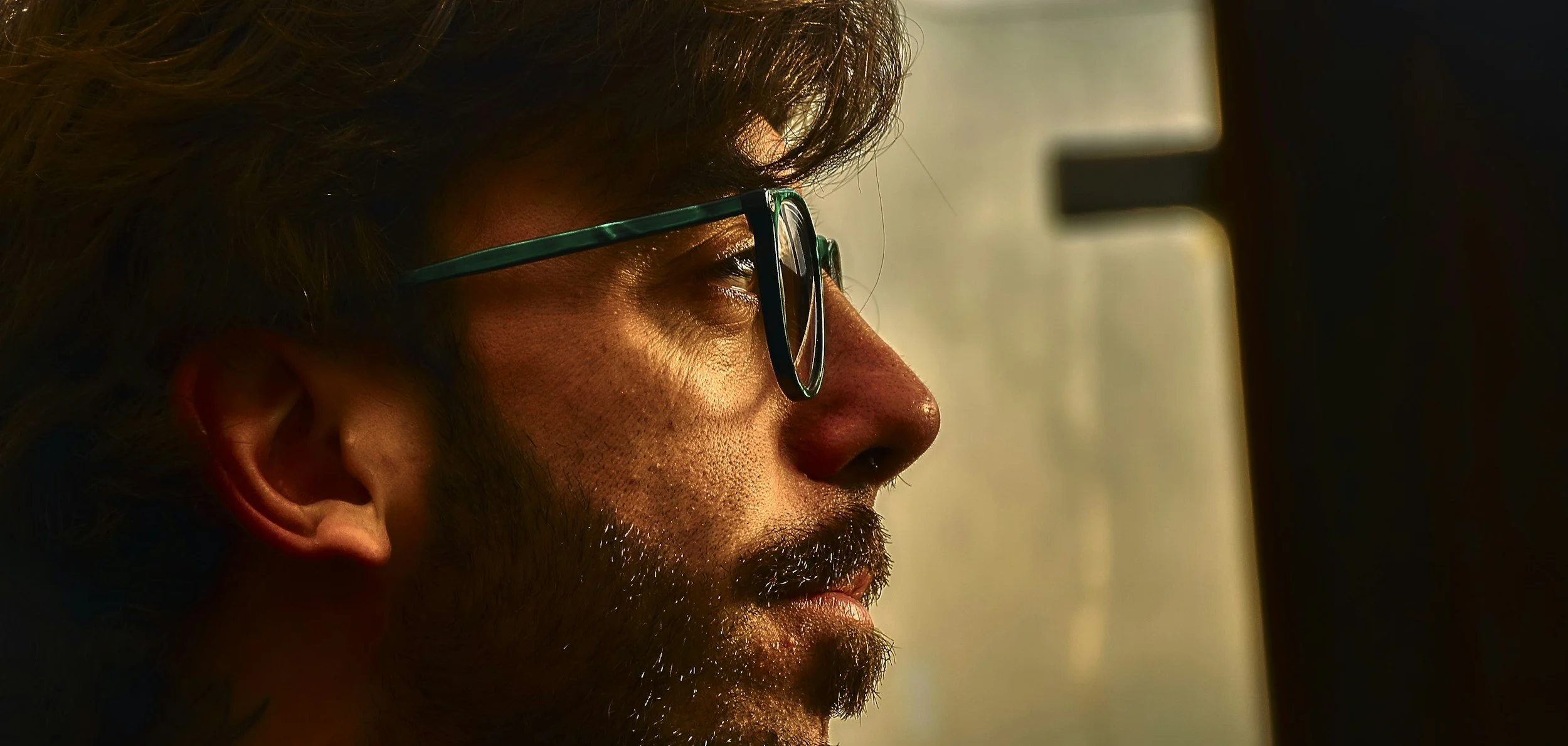 Close-up profile of a man with glasses reflecting quietly, representing the personal readiness assessment for an EMDR intensive