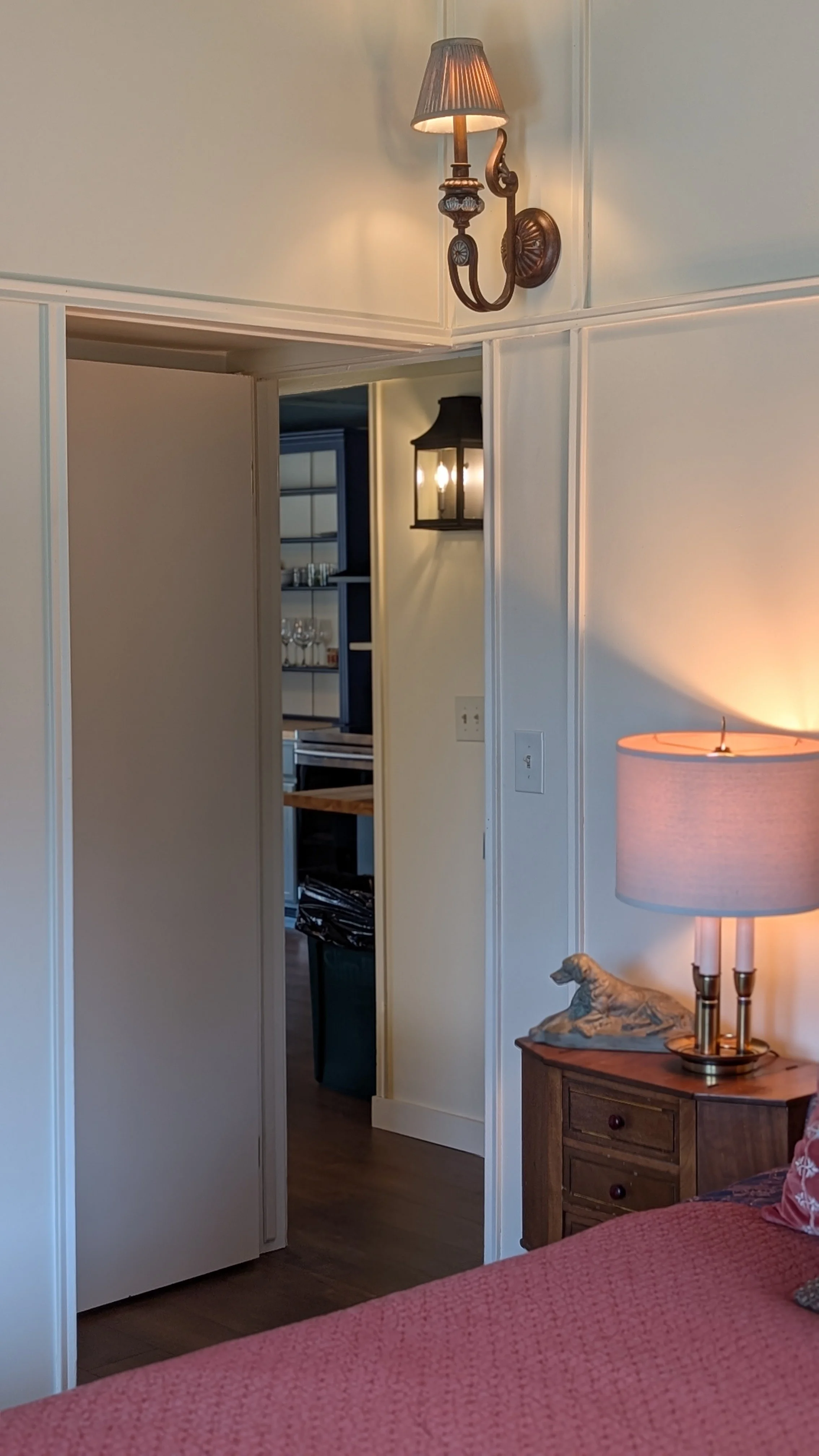 From the master bedroom looking through to the hallway, beautiful sconce lighting throughout the cabin.