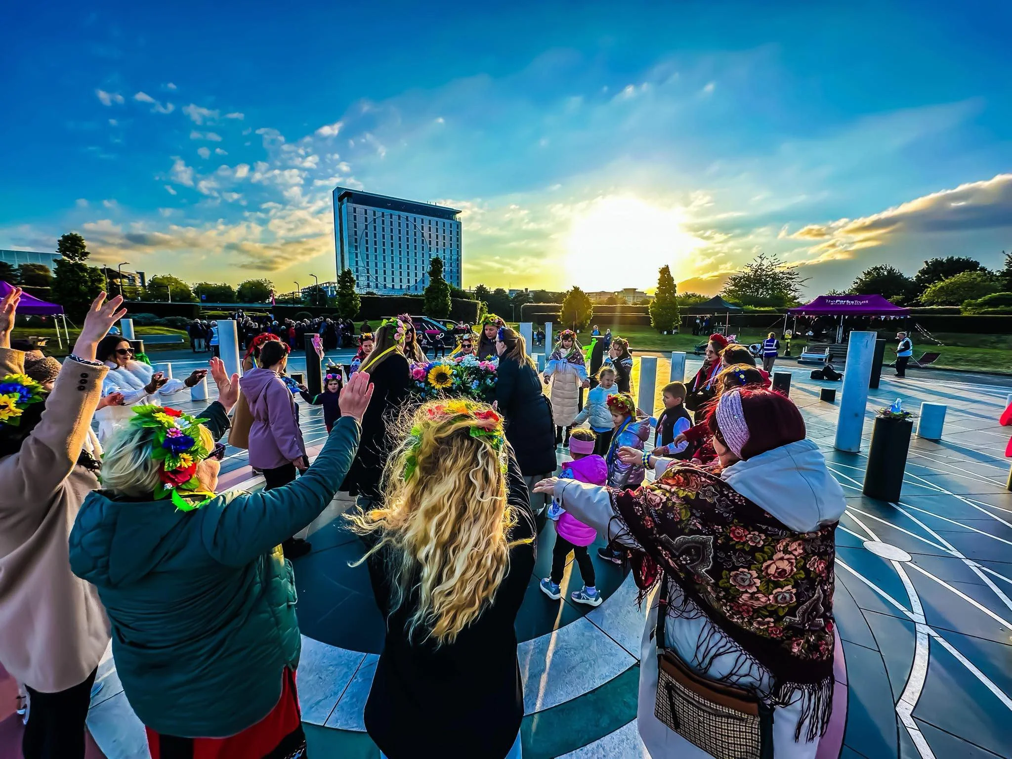 A group of people dancing in a circle as part of a Ukrainian community celebration