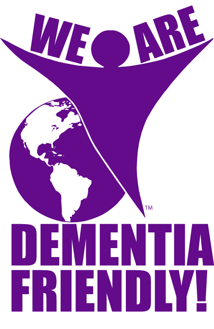 Purple logo with the text "WE ARE DEMENTIA FRIENDLY!" around a stylized globe and a person reaching upward, symbolizing awareness and support for dementia.