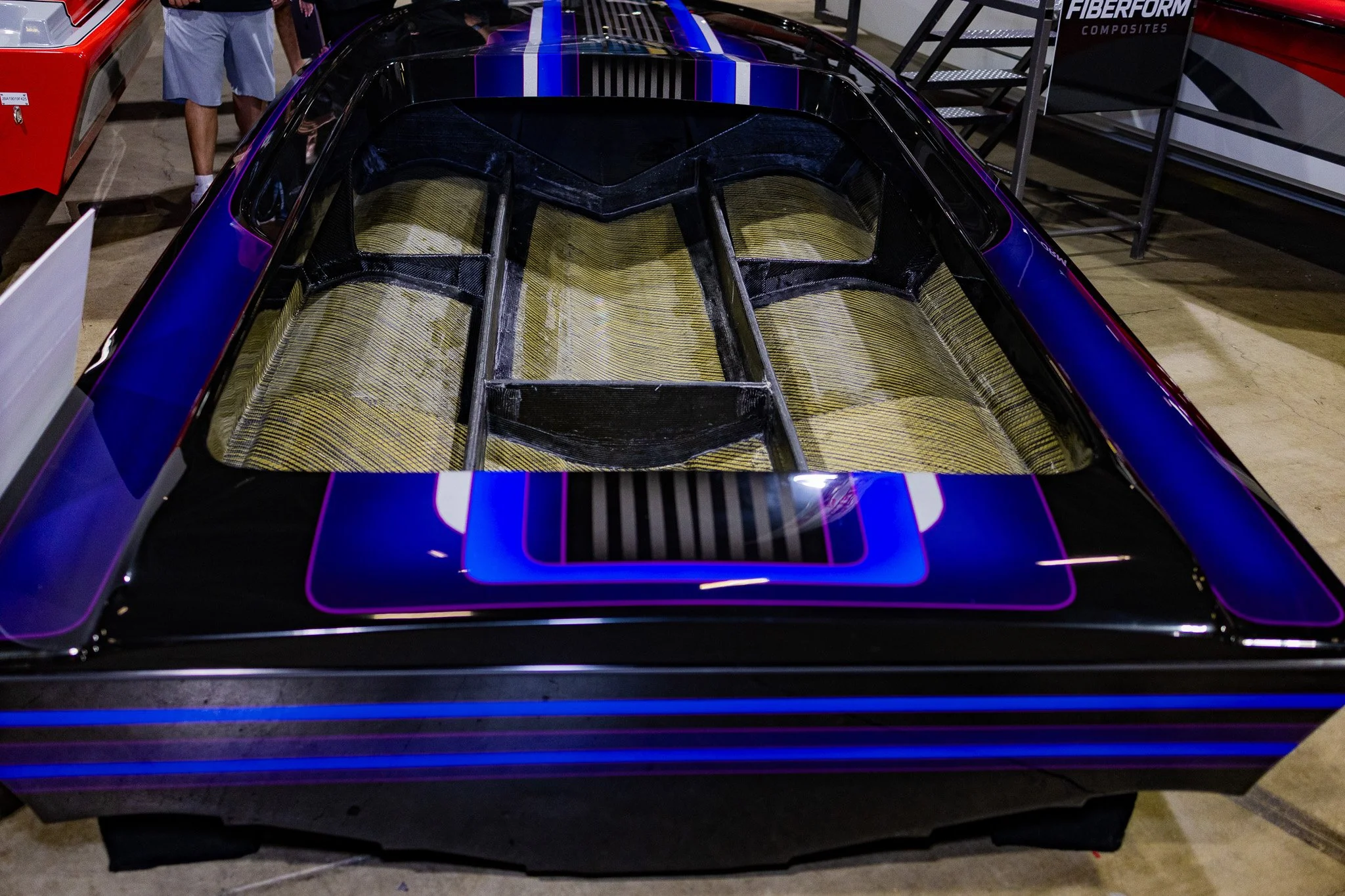 Close-up view of a boat hull showing the interior, painted in black with blue and purple accents.