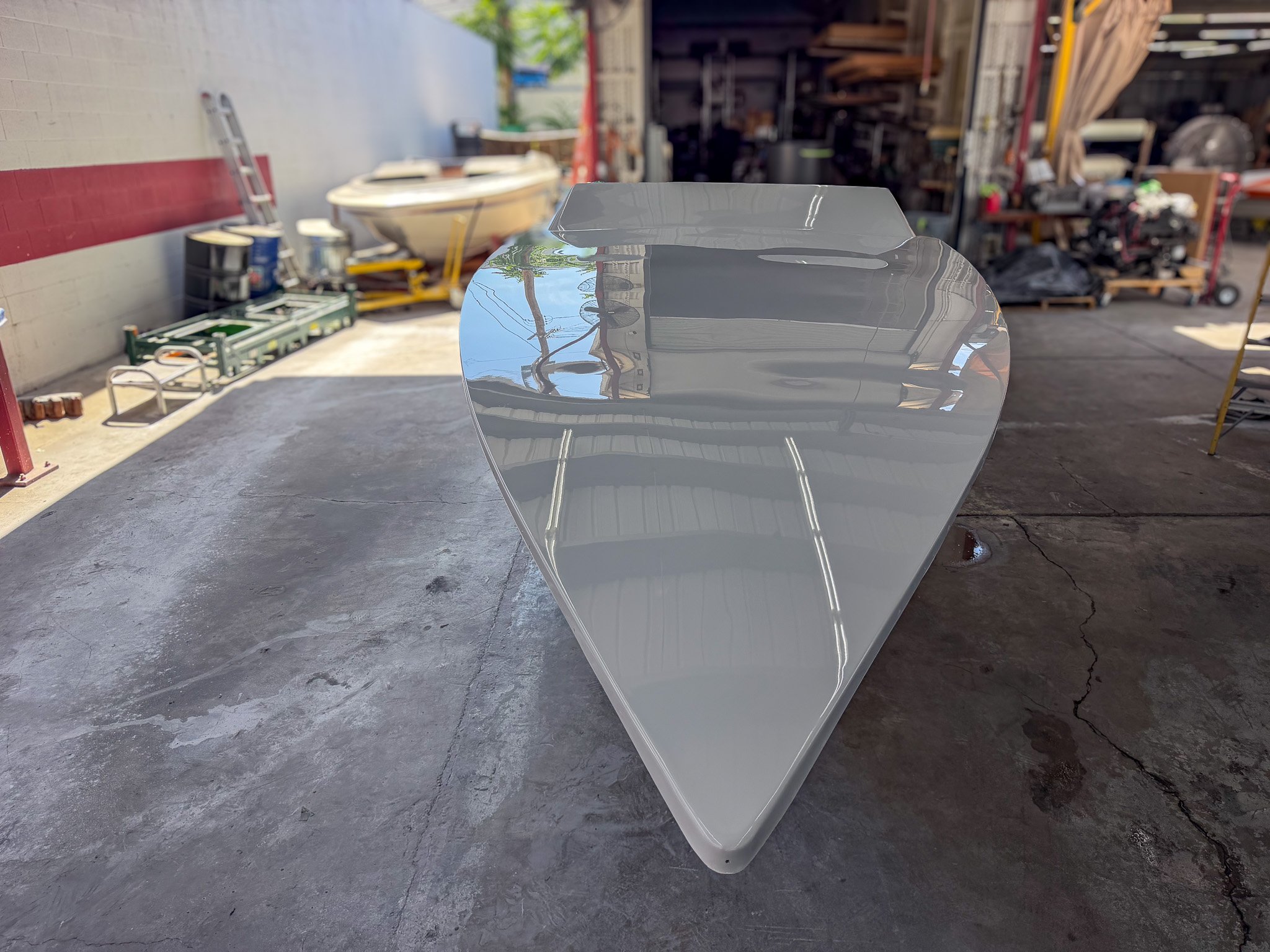 bow and deck of a fiberglass boat hull in a boat shop