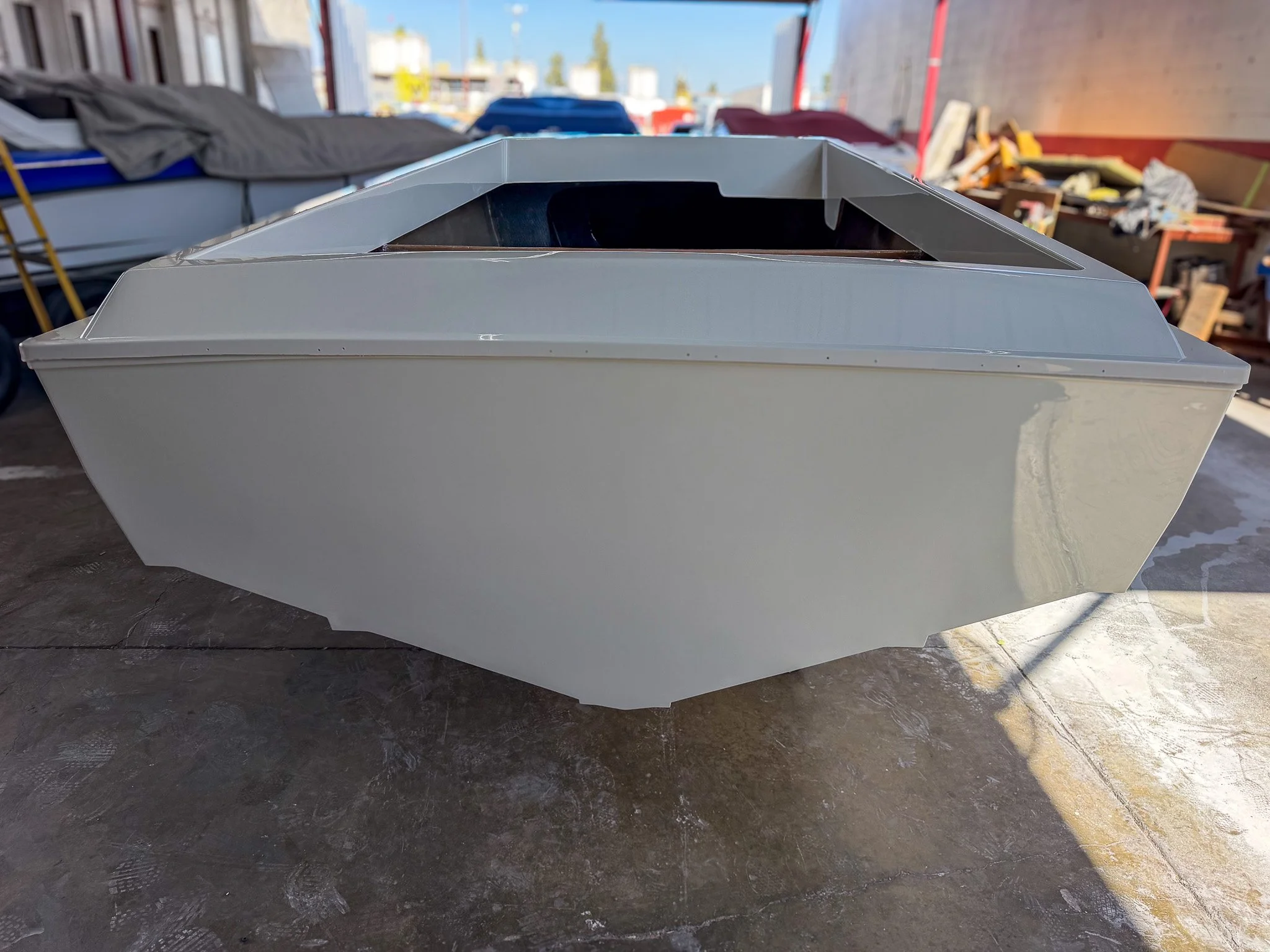 white boat hull made from fiberglass in a boat shop