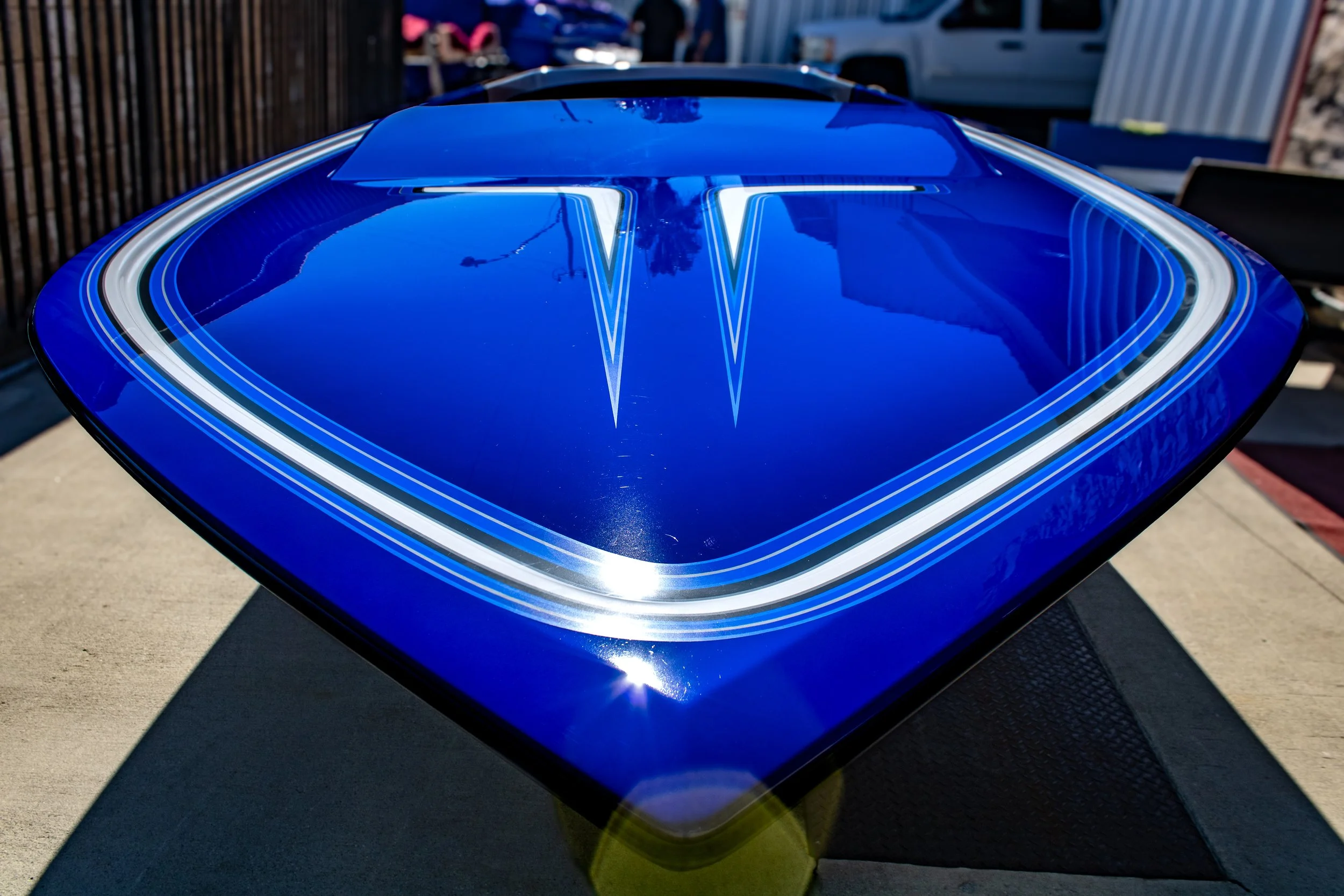 Blue boat hull photographed outdoors.