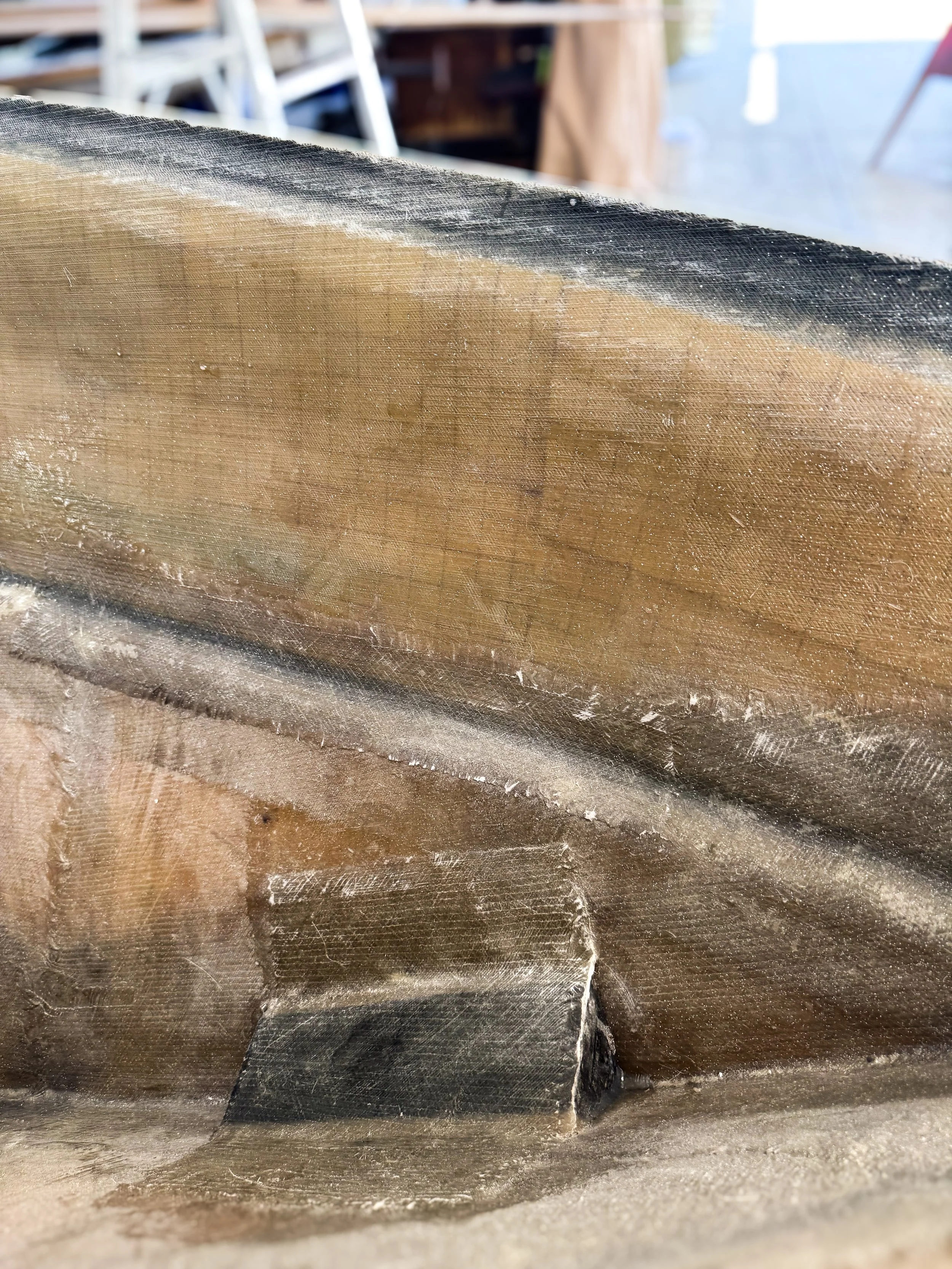 Close-up of the inside of a boat hull showing fiberglass and coring