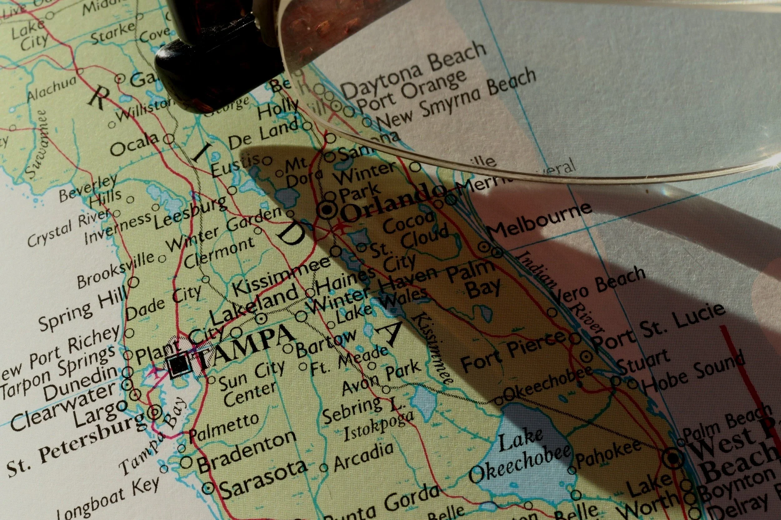 Close-up of a map of Florida focusing on the Orlando and Tampa areas, with a black stamp partially visible at the top.