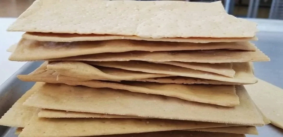 Stack of flatbread or crackers on a tray.