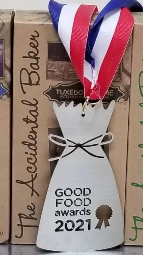 The Accidental Baker's Tuxedo Sesame flatbread crackers pictured with its Good Food Award Medal for 2021.