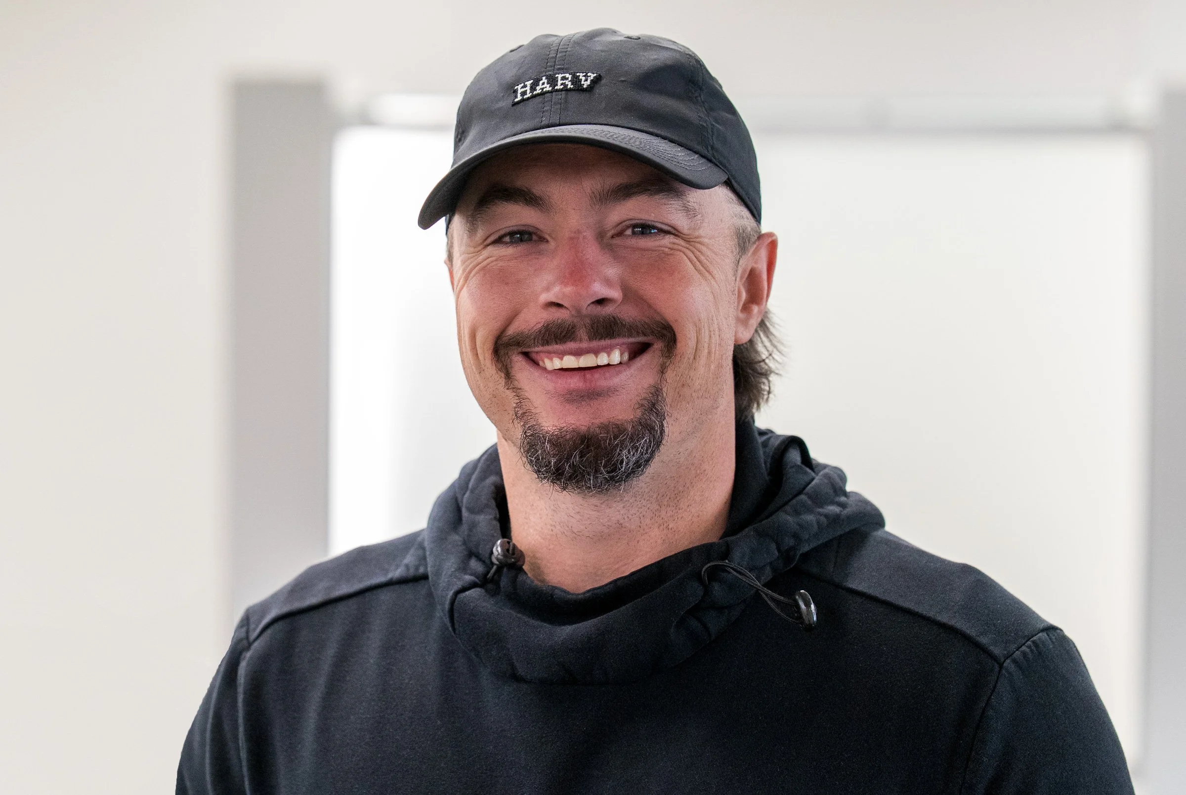 Danny Woodhead - CEO - Arise Ventures - Photo of Danny smiling at the camera in front of a bright background.