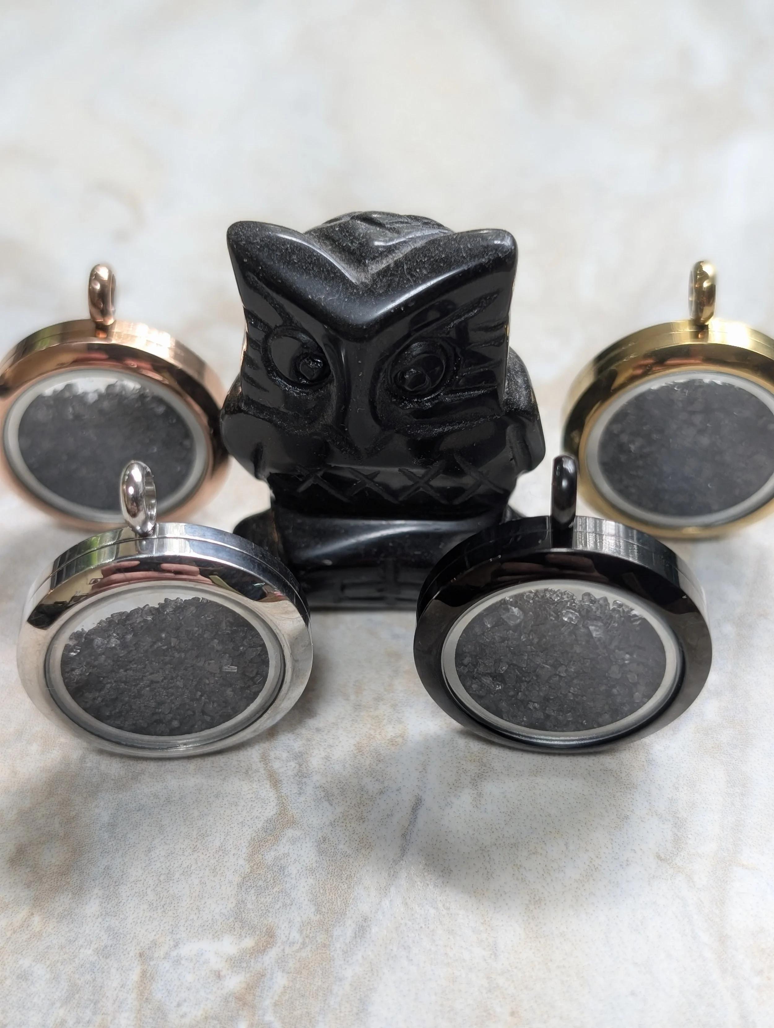 Protection Lockets of in colors of black, silver, gold and rose gold filled with black salt.