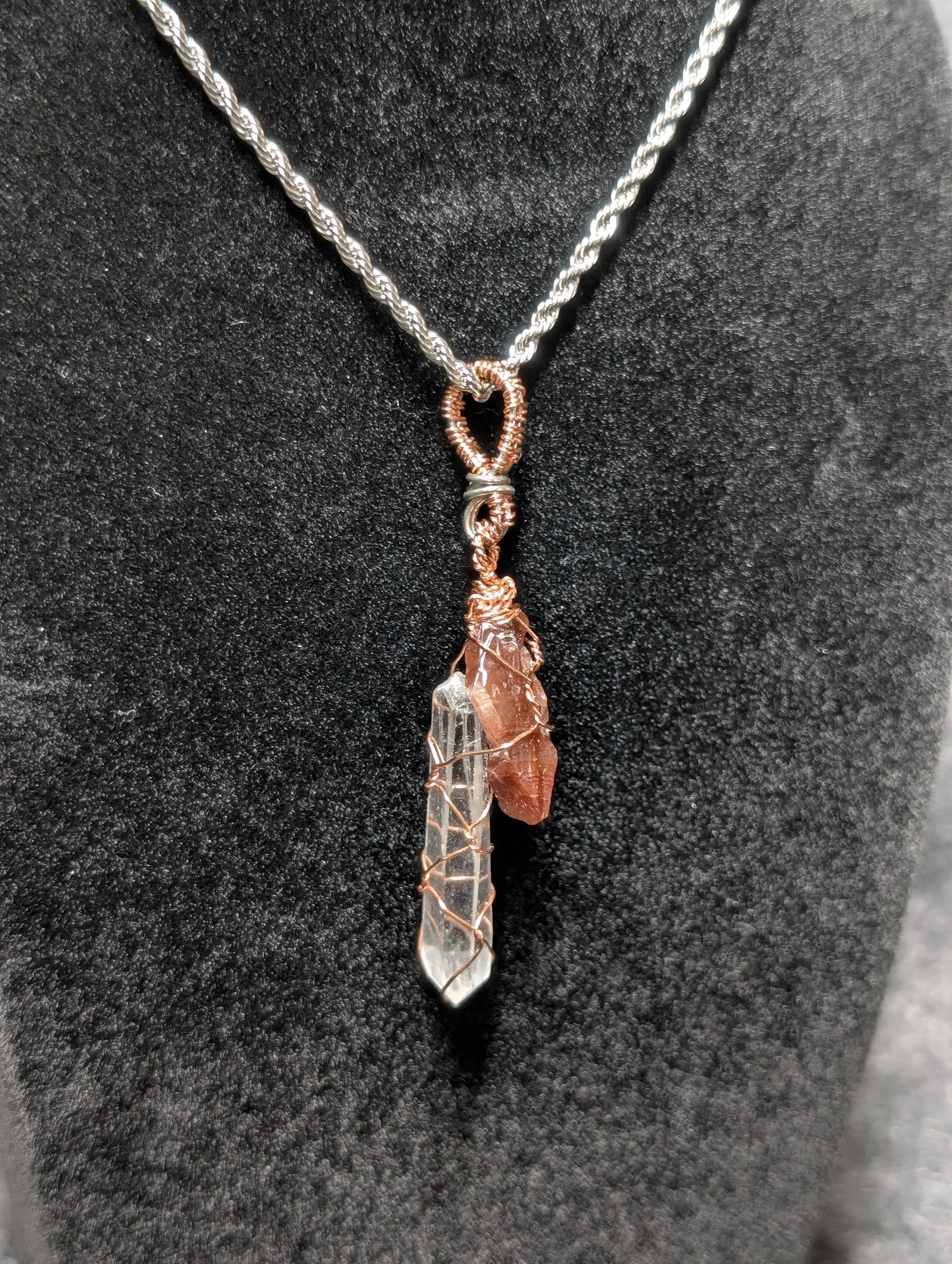 Woven wire pendant with copper and silver. Copper wrapped clear quartz point with Red Calcite 
