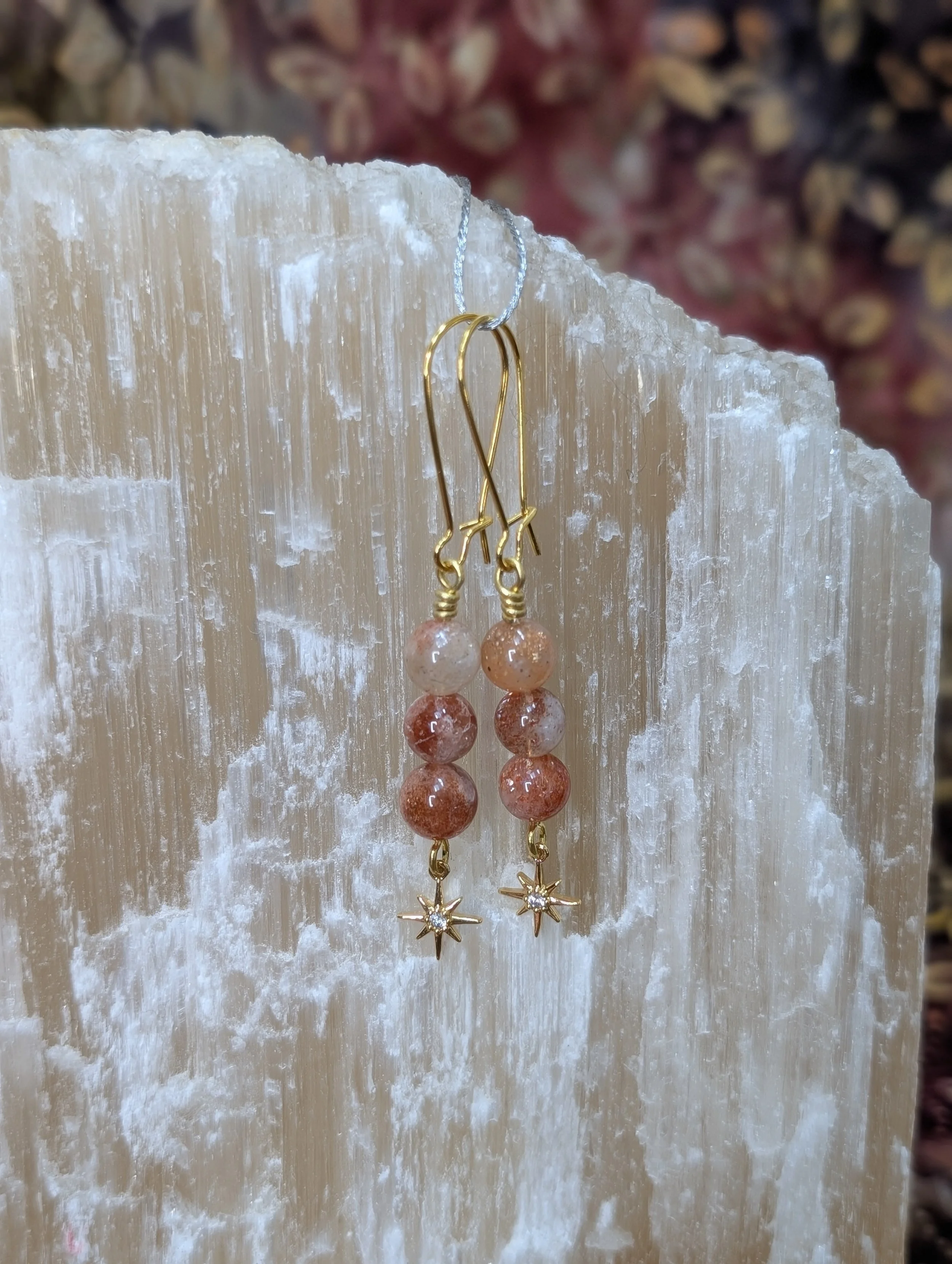 Gold sunstone earrings with star charms
