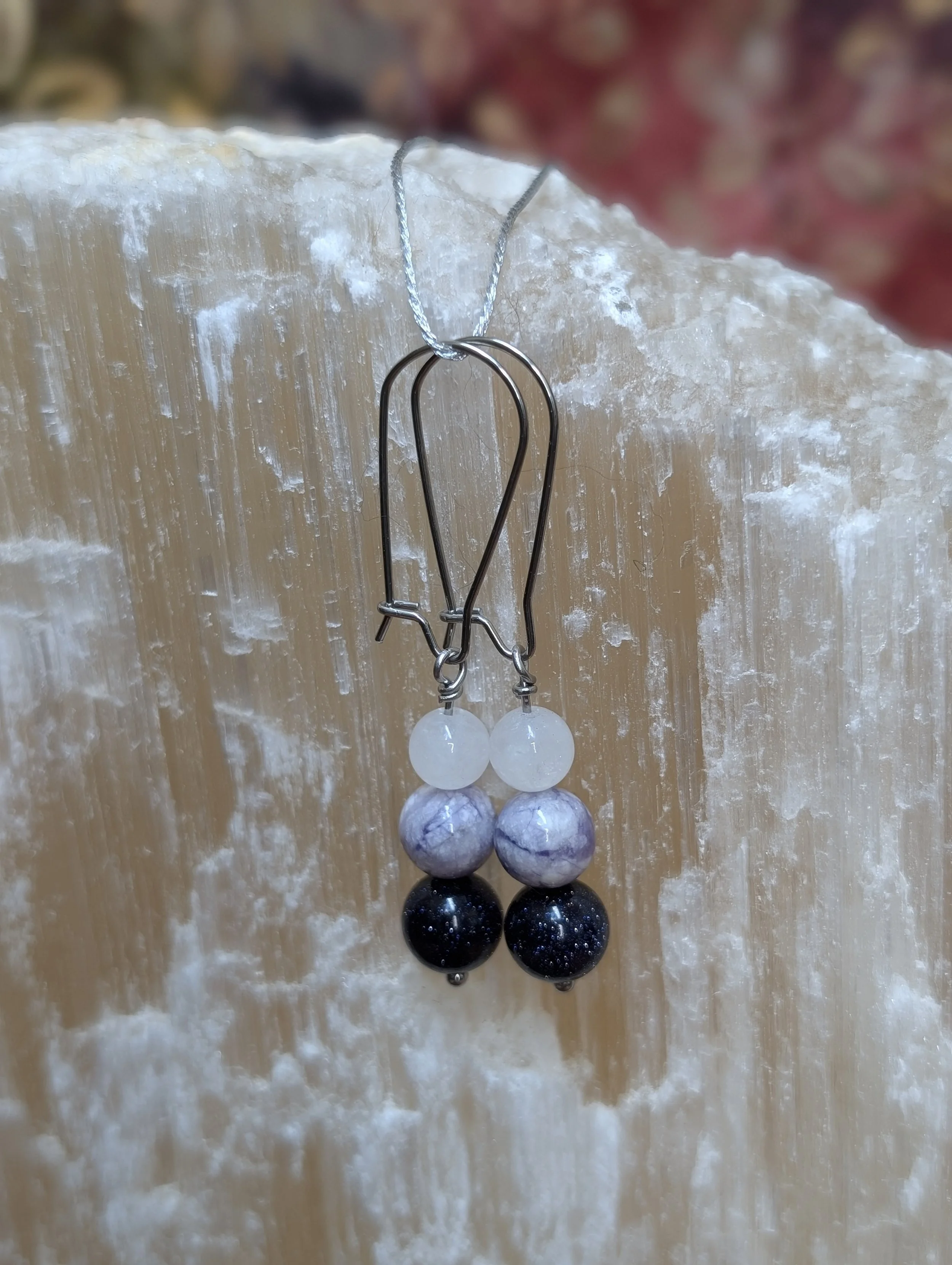 Earrings made with white jade, fancy jasper, and purple goldstone