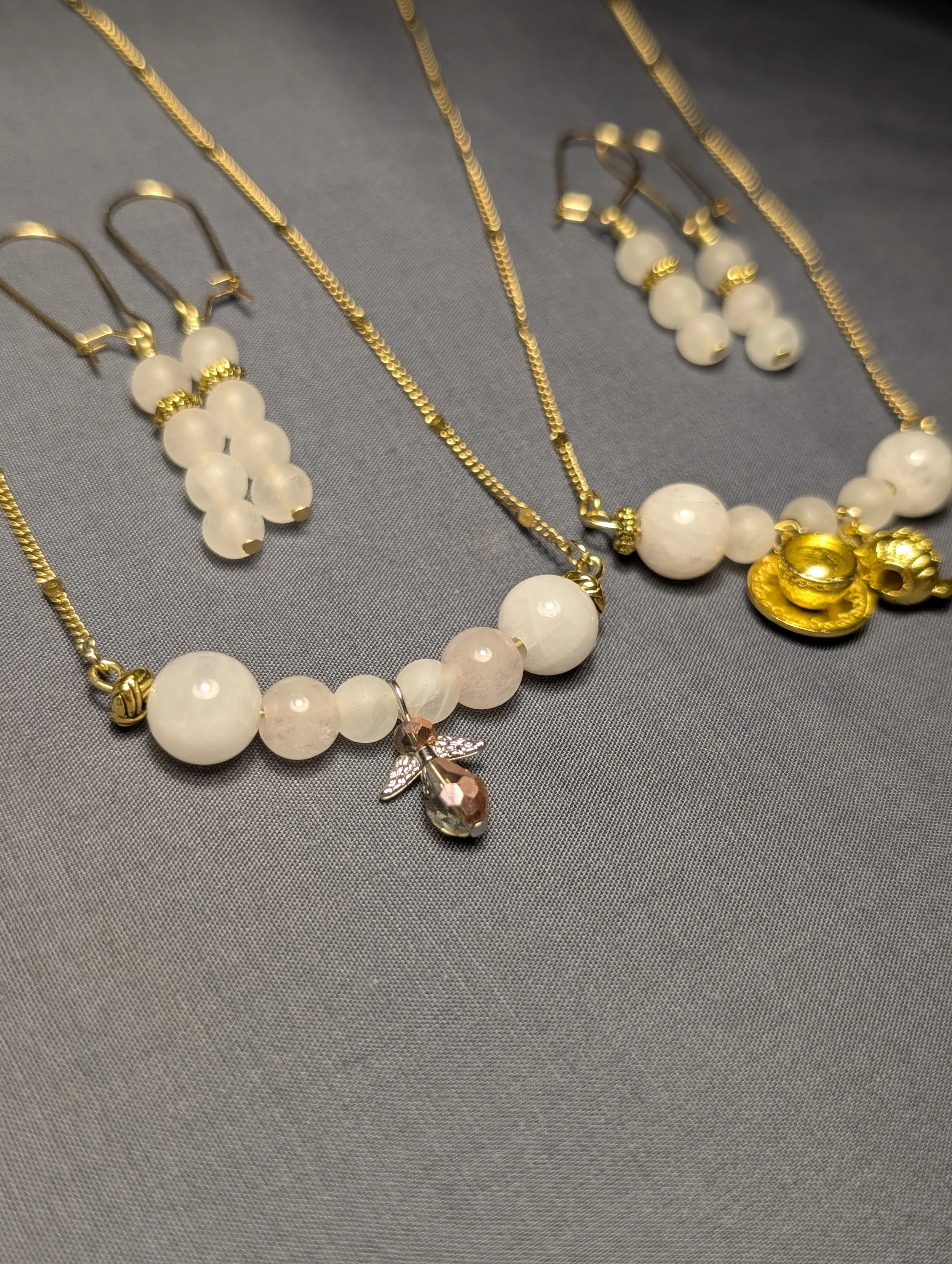 A set of gold necklaces and earrings made with rose quartz