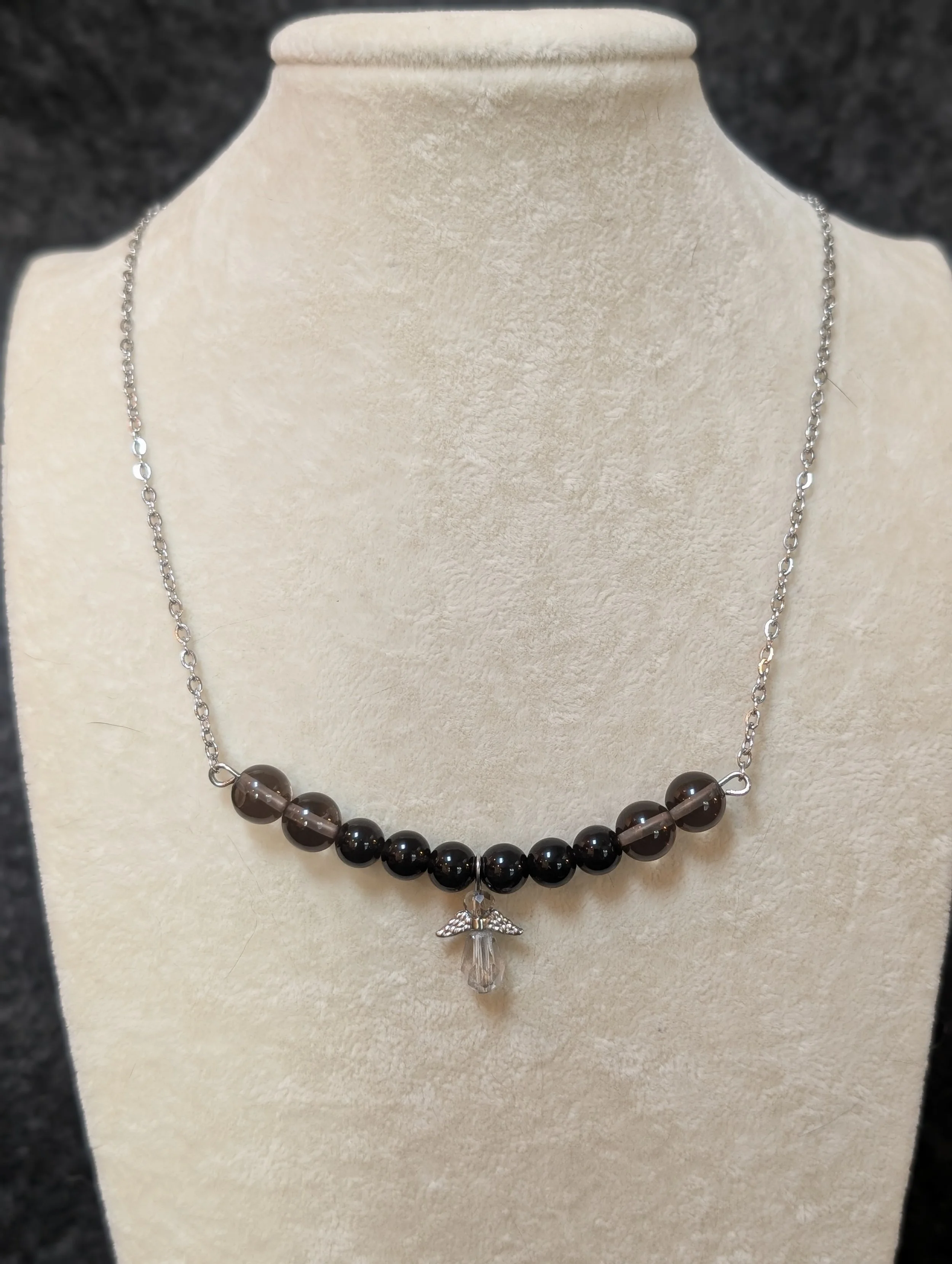 A necklace that was jointly designed by a cat and dog that have passed