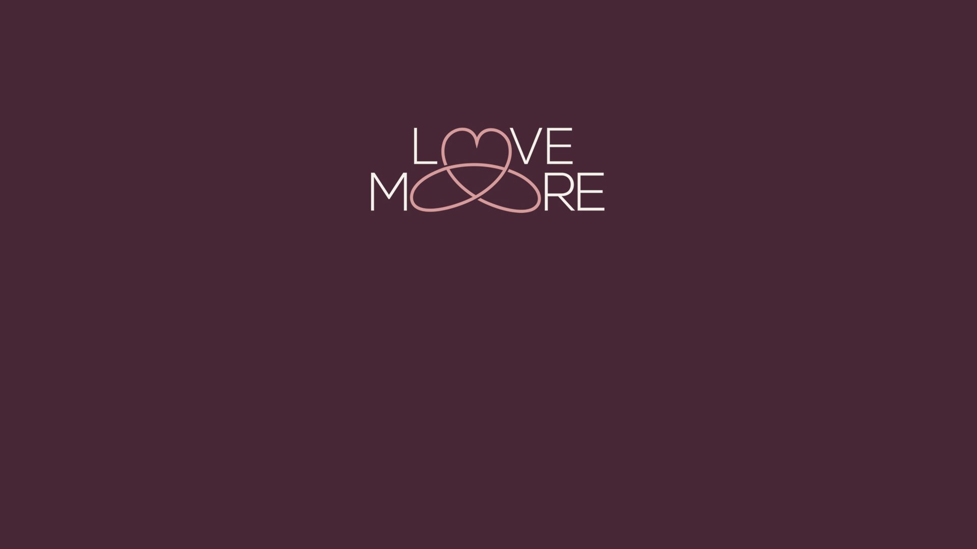 Dark purple background with the words 'LOVE MORE' in white and pink, interconnected with two overlapping pink heart outlines.