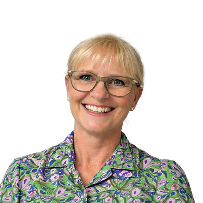 Smiling woman with short blonde hair, glasses, and a colorful patterned shirt against a white background.