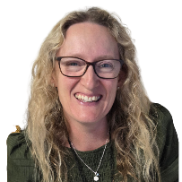 A woman with curly blonde hair, wearing glasses, smiling, and dressed in a dark green top with a necklace, against a white background.