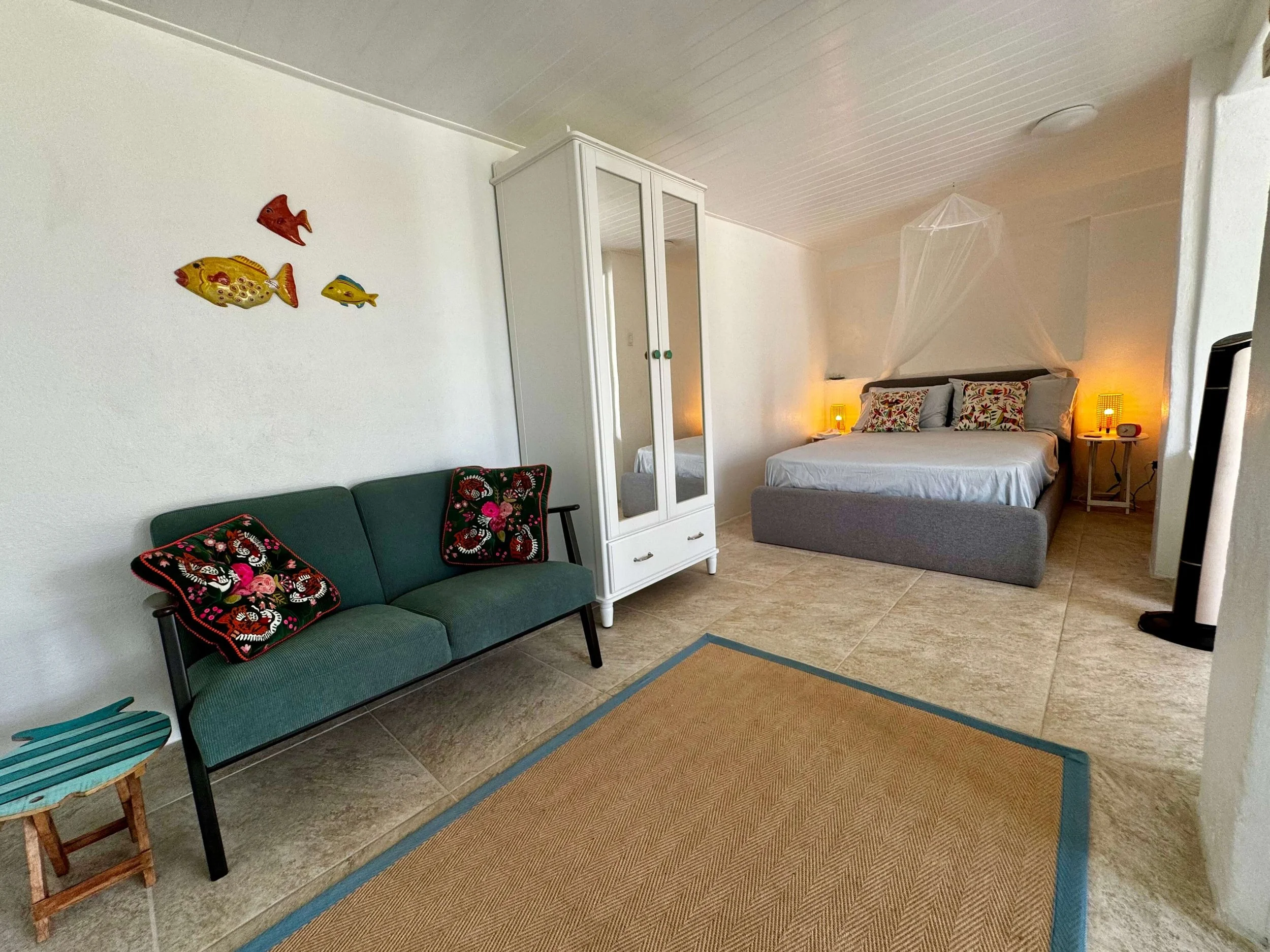 The inside of the studio at The Sea Change Retreat in Crabbe Hill, Antigua with a comfortable double bed, sitting area to dream your new era into being.