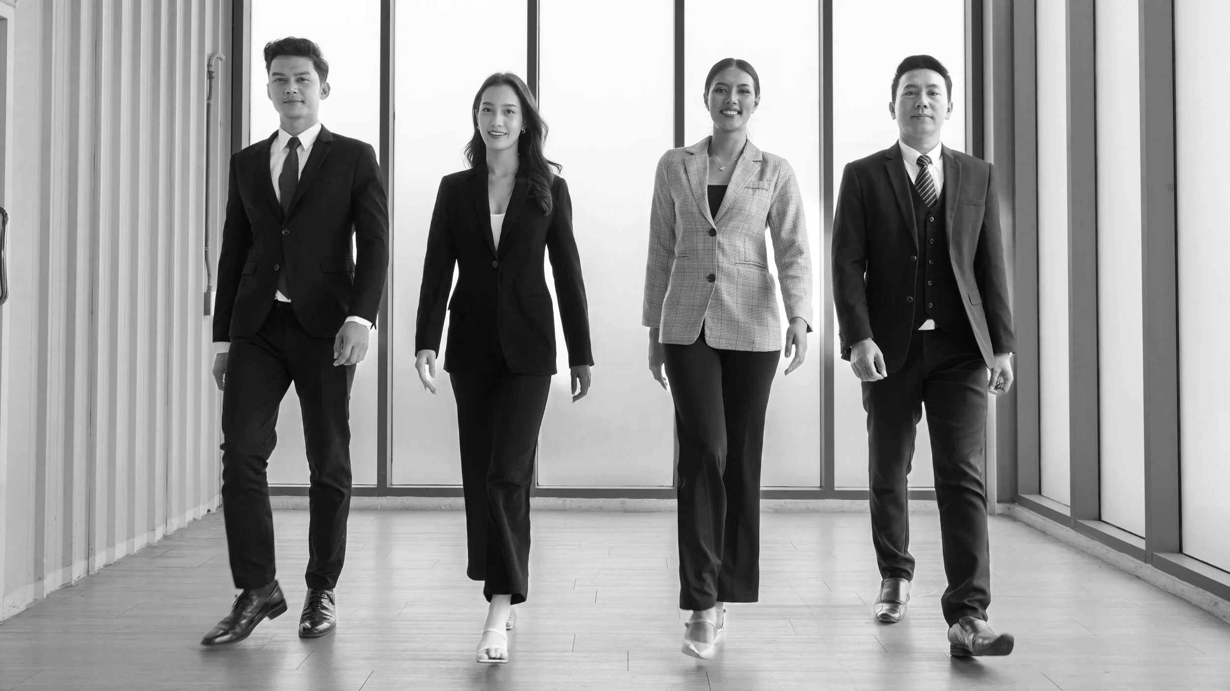 Professional team walking confidently in a modern office — representing the trust, reliability, and professionalism behind GoodMaids household services.