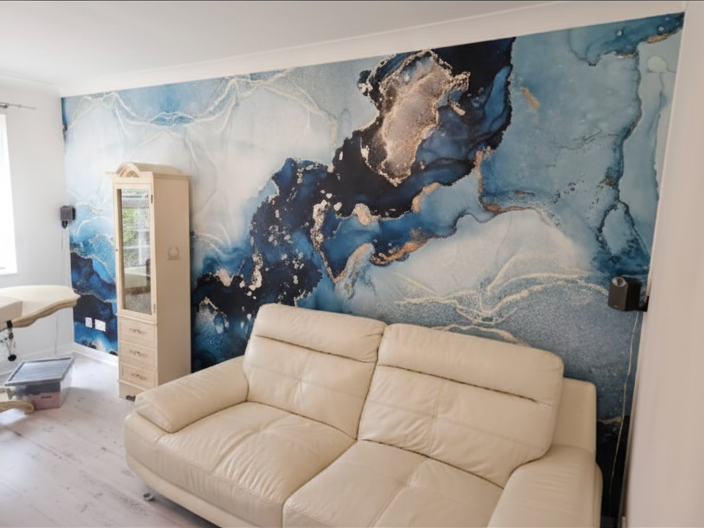 A dramatic feature wall with a striking marble-effect wallpaper. Careful alignment and precision hanging ensure the flowing design looks seamless across the entire wall. This kind of bold print makes a real statement in a living space — and getting t