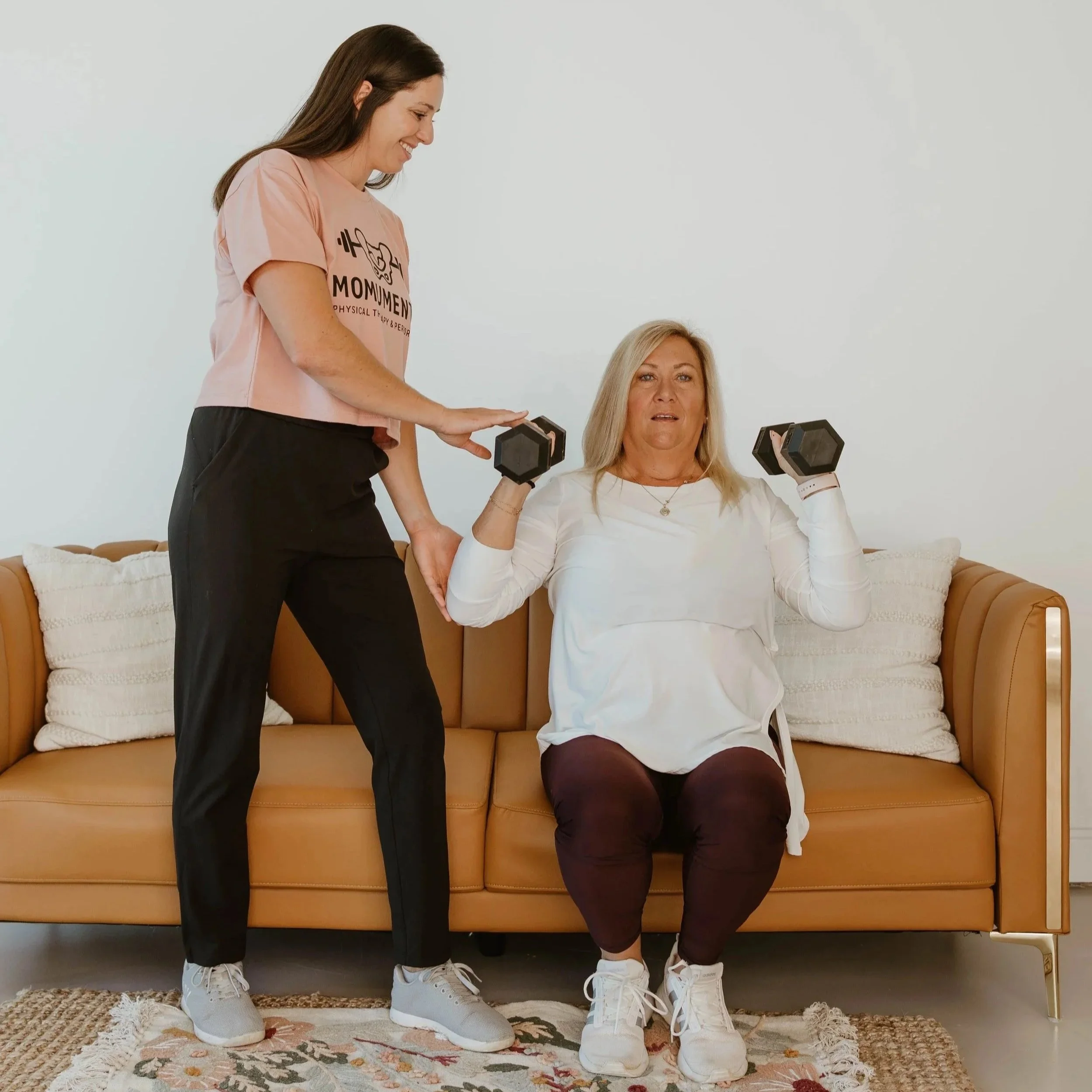 Women's personal training in Cumming, Georgia. Postmenopausal women working out and lifting dumbbells in Cumming, Georgia.