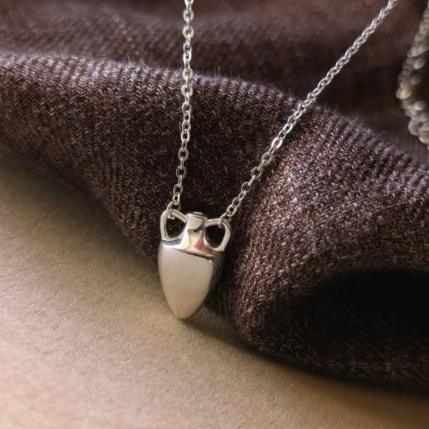 The last sun of Summer sun crept unhurriedly from behind the vineyard covered hills, and before long, the navy sky began to glow with layered streaks of gold, violet and teal.

Watching the light change from his small workshop window, Elias wiped his