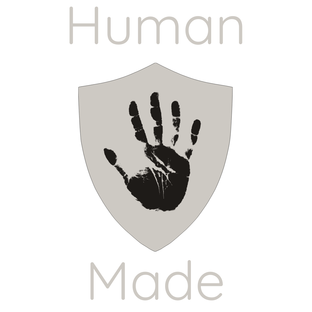 Logo with a black background, a gray shield, a black handprint inside the shield, and the words 'Human Made' above and below the shield.