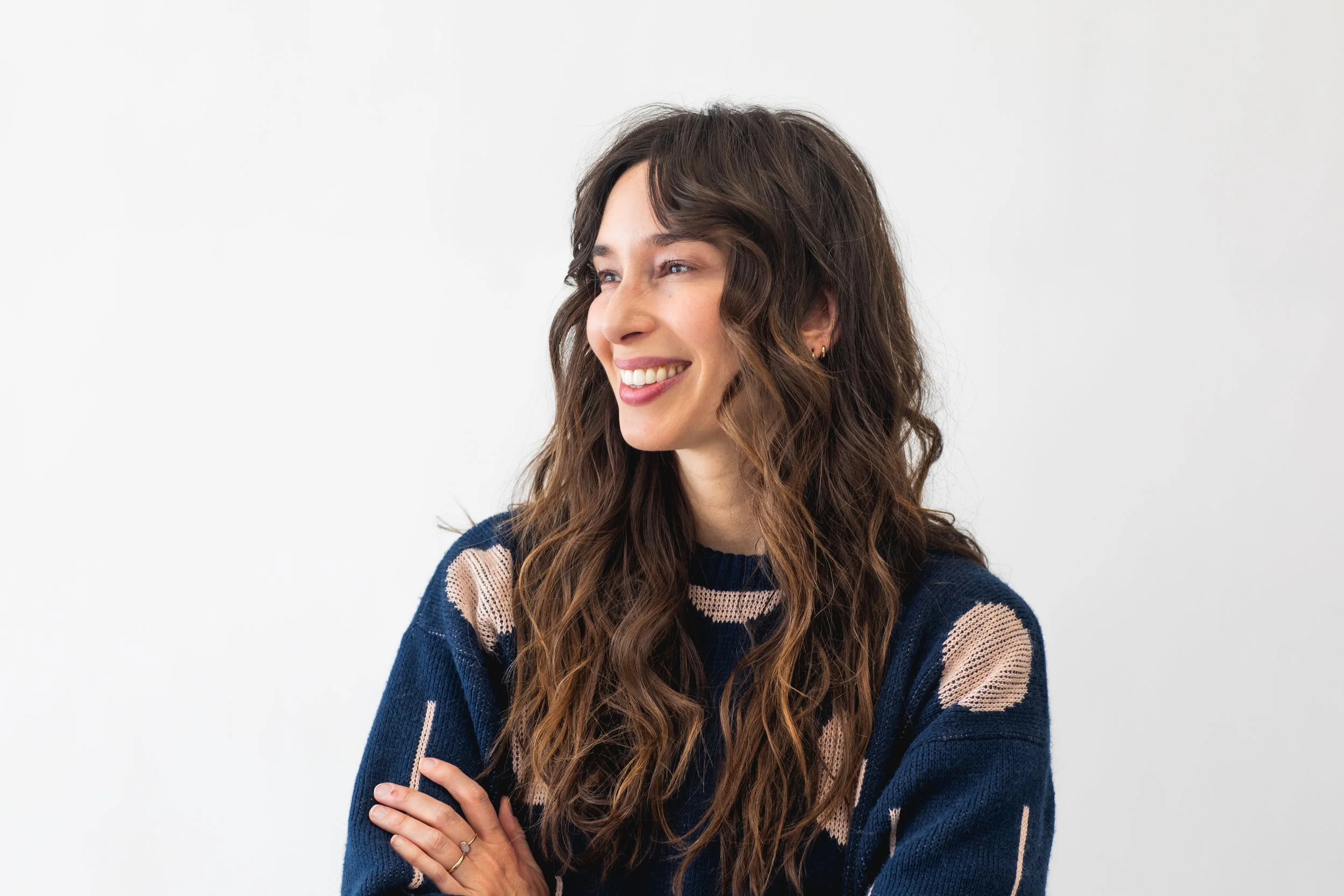 Natural, textured waves on long brunette hair with subtle warm highlights that enhance movement and shine. A perfect low-maintenance style for clients who want a soft, effortless look that still feels polished. brunette hair Atlanta, natural waves ha