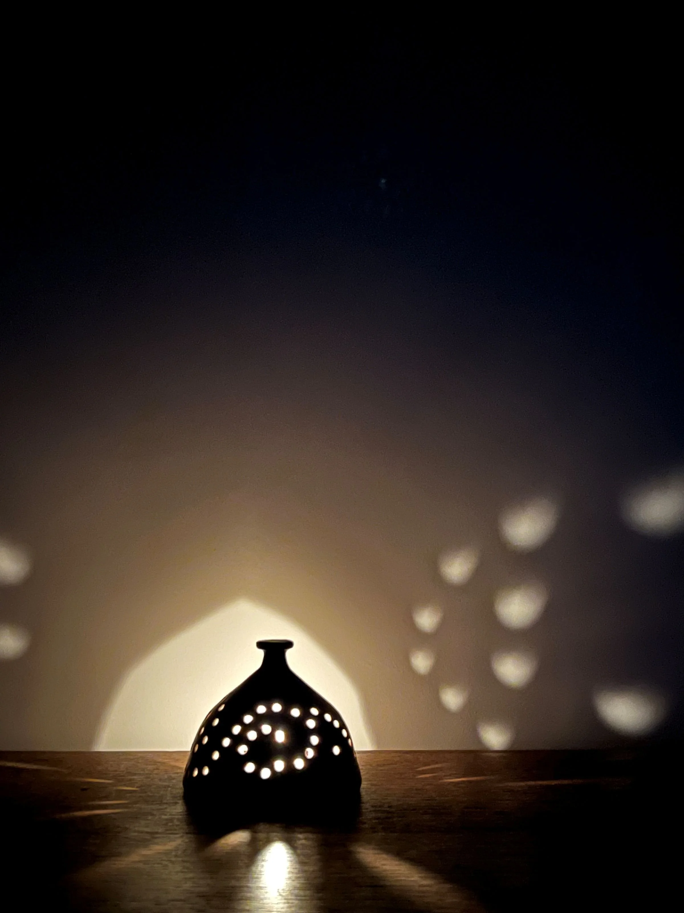 Stoneware luminary at night.